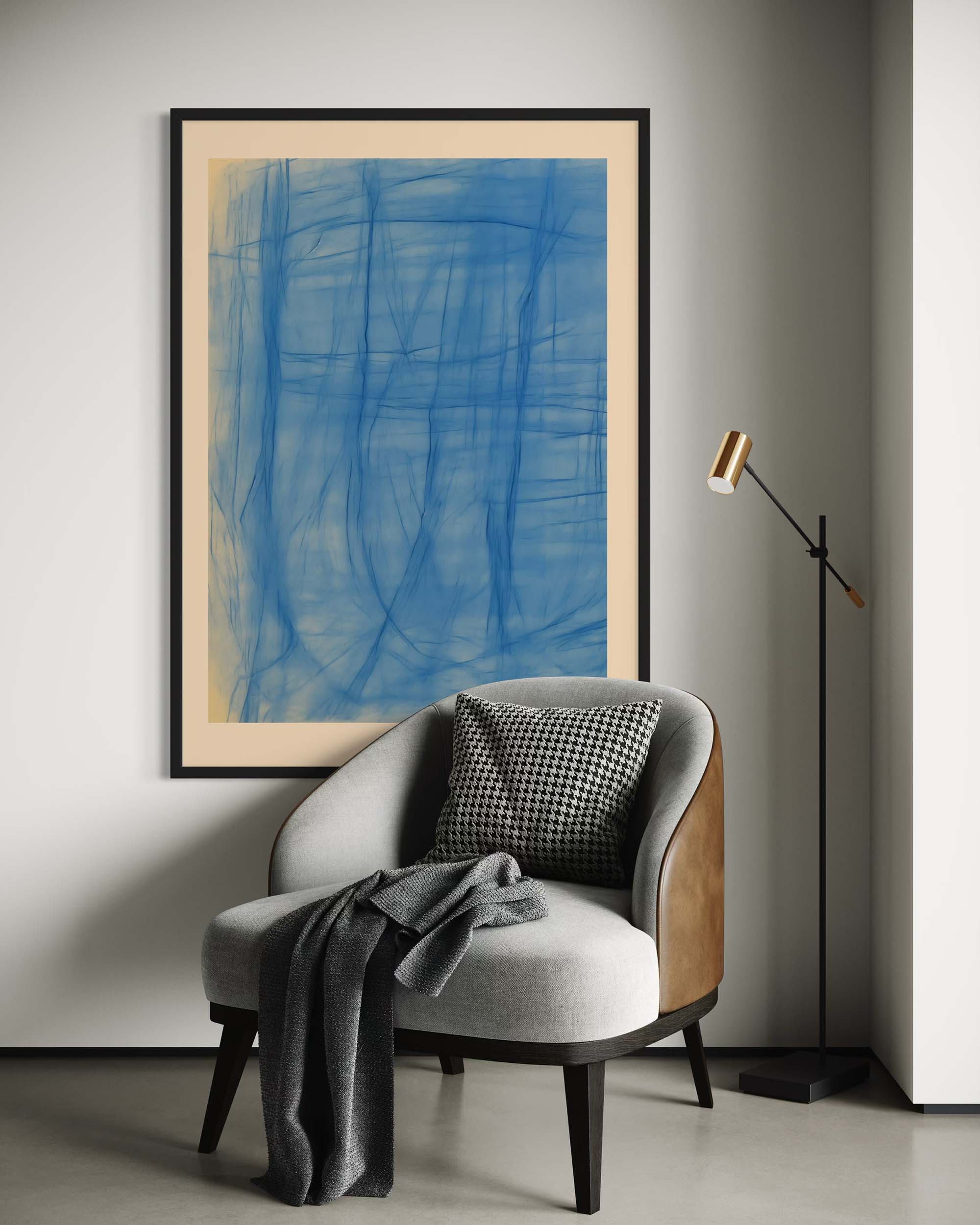 Large blue abstract picture above a sofa in a styled living room