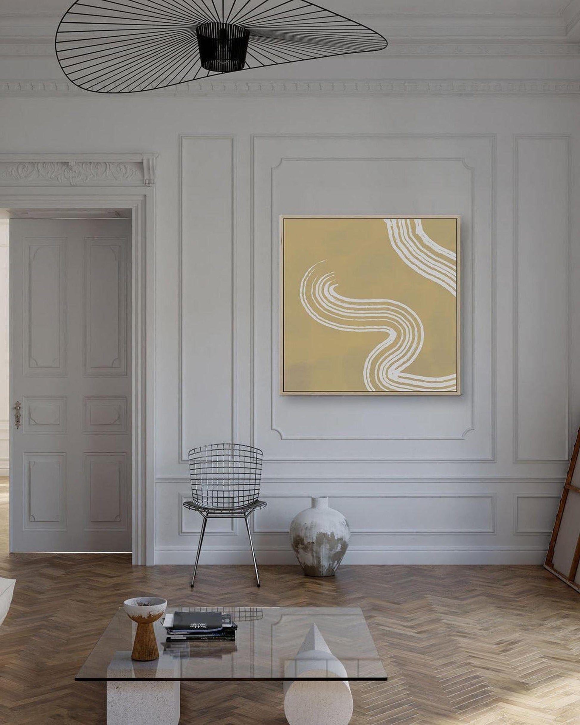 Modern living room with abstract art, chair, and coffee table.