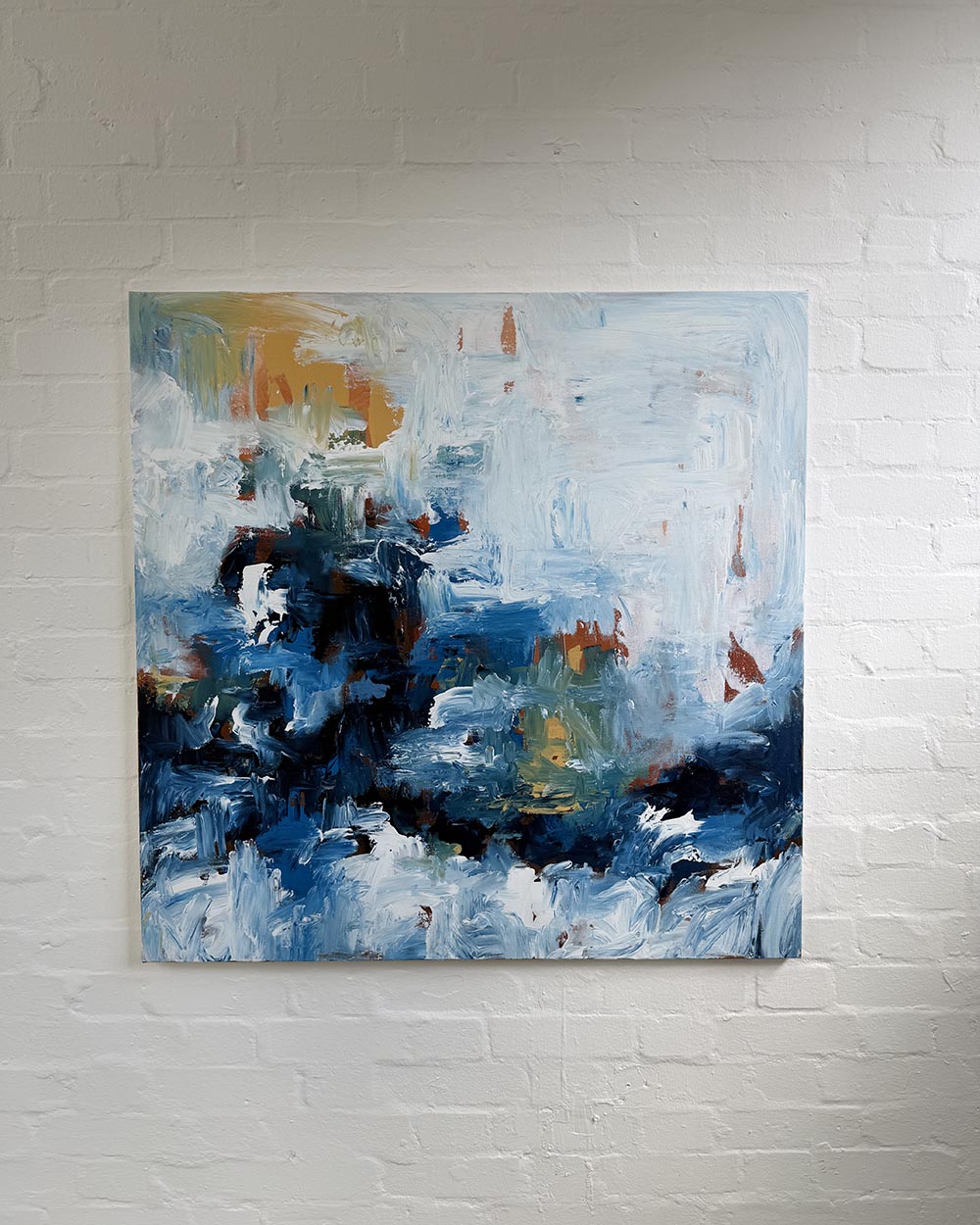 Abstract painting on a white brick wall