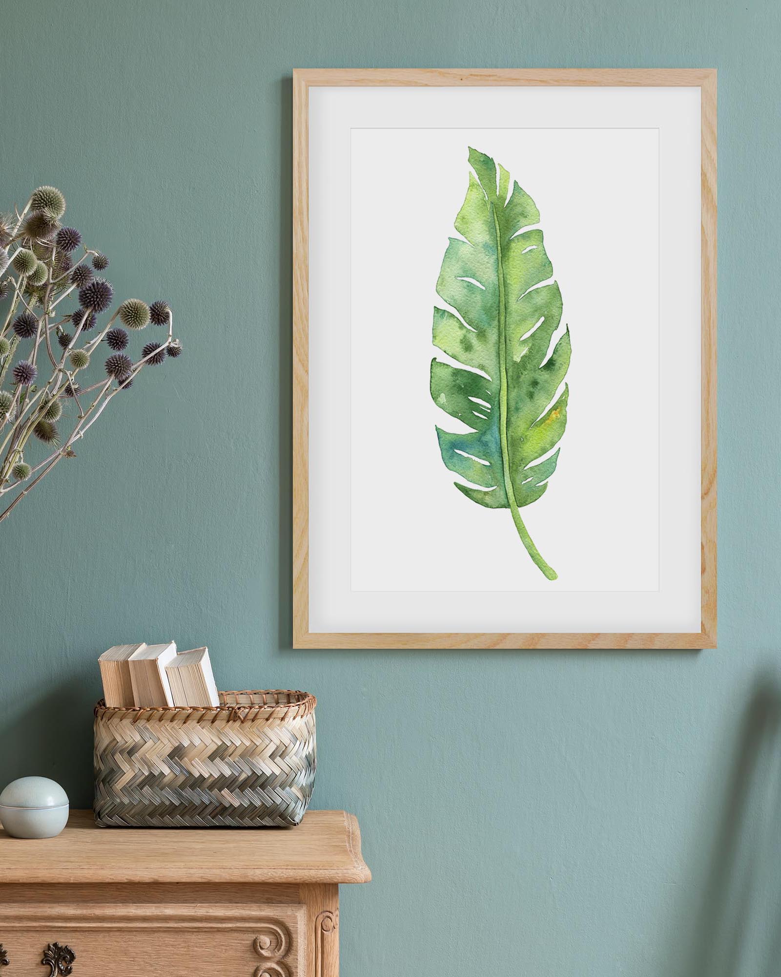 framed botanical art print on a teal wall
