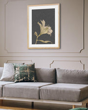 Gray sofa with a decorative pillow and framed artwork on a wall.