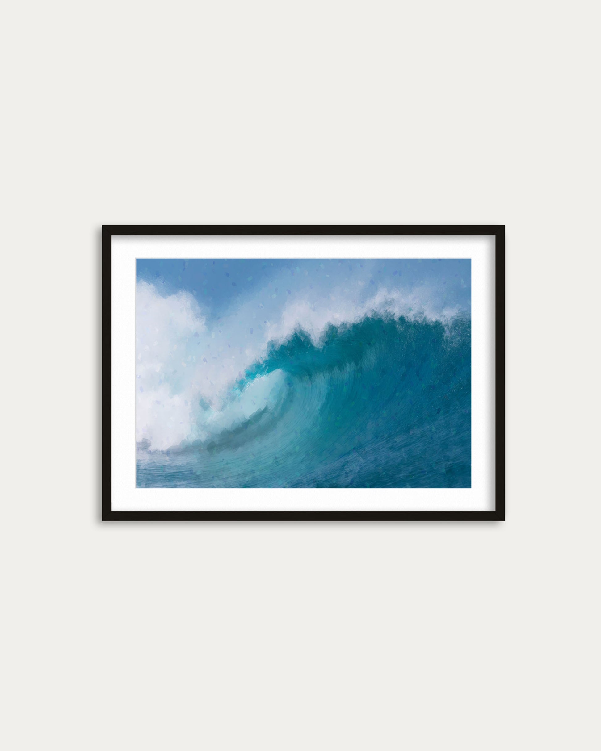 Framed photograph of a large wave in the ocean on a white wall