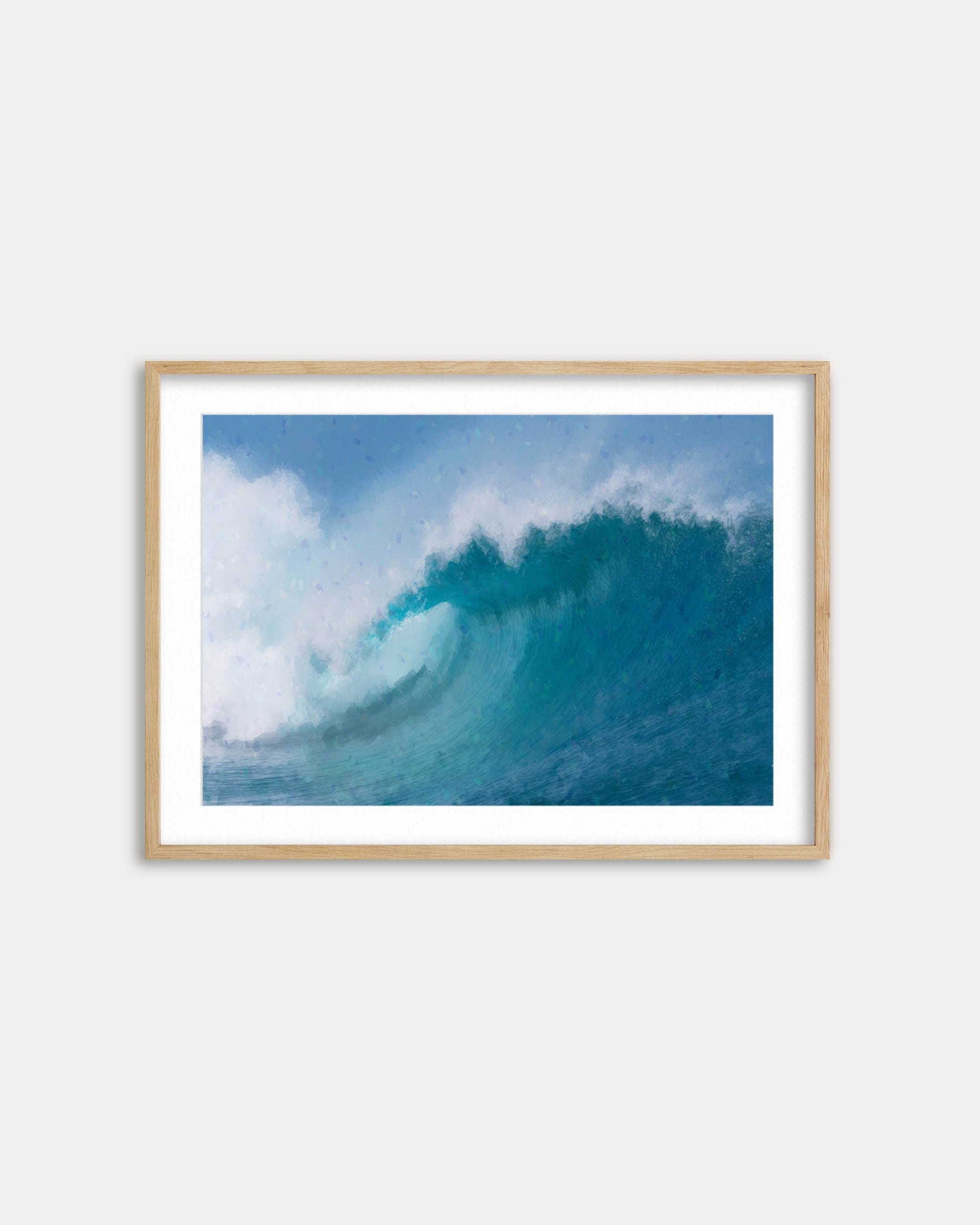 Framed photograph of a blue ocean wave on a white wall
