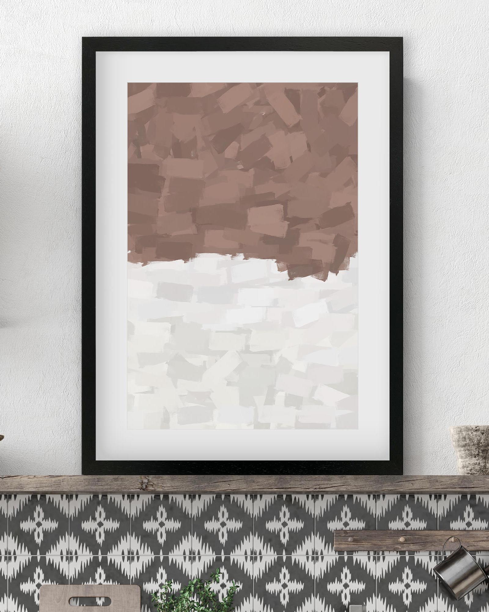 Framed abstract art print with brown and white pattern on a wall.