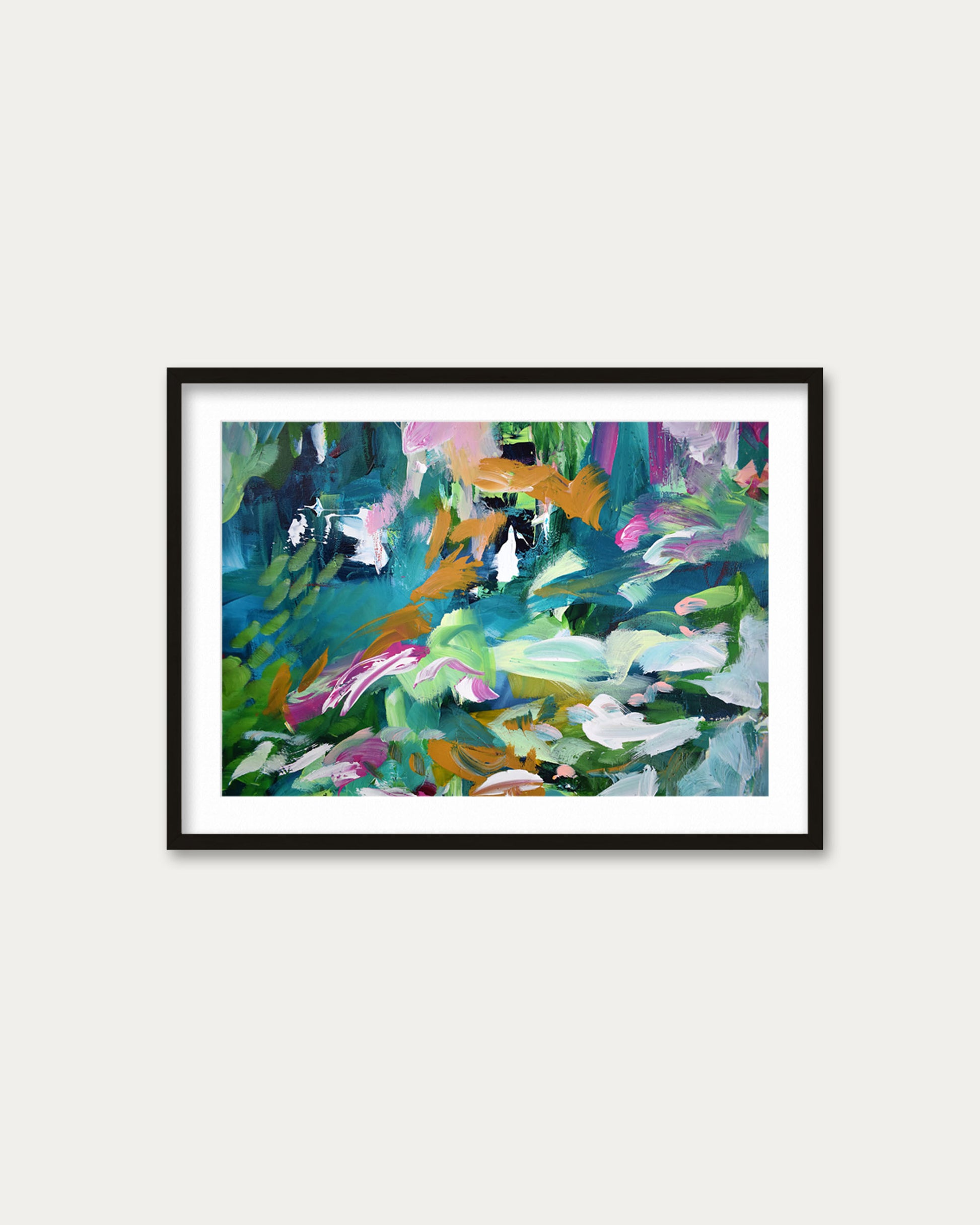 Framed abstract painting with colorful abstract design on a white wall