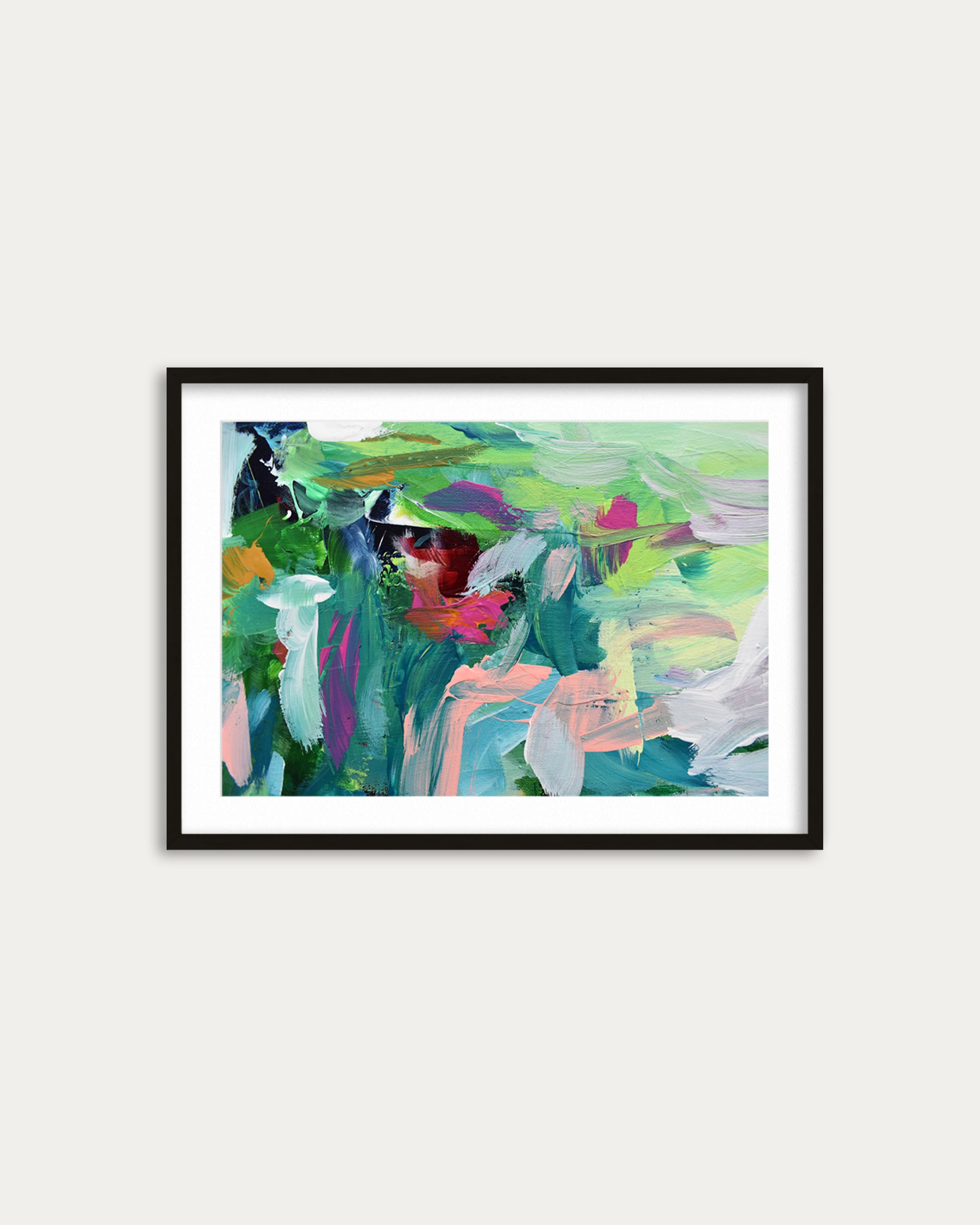 Framed abstract painting with colorful brushstrokes on a white wall