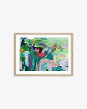 Framed abstract painting with colorful brush strokes on a white wall