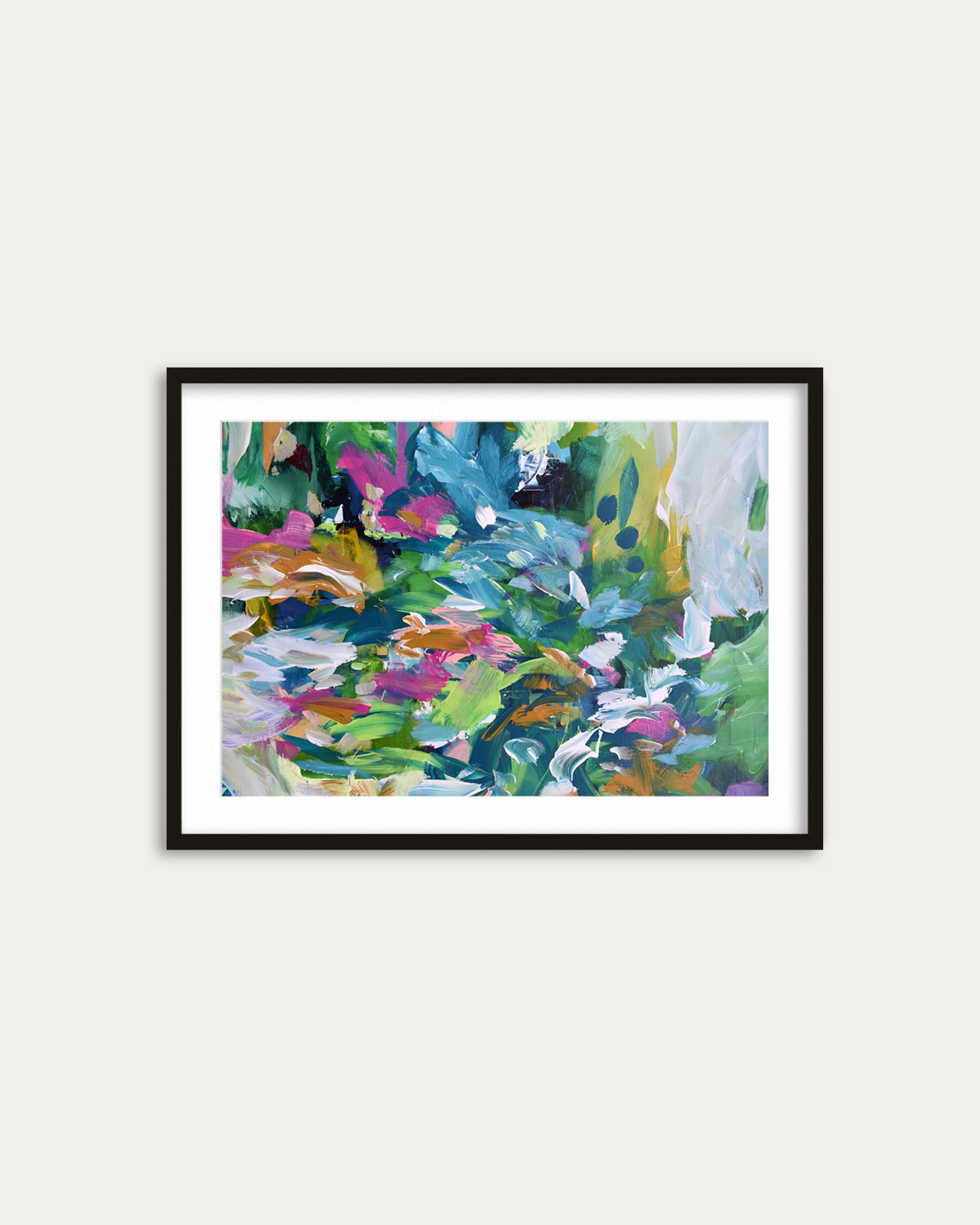 Framed abstract painting with colorful brush strokes on a white wall
