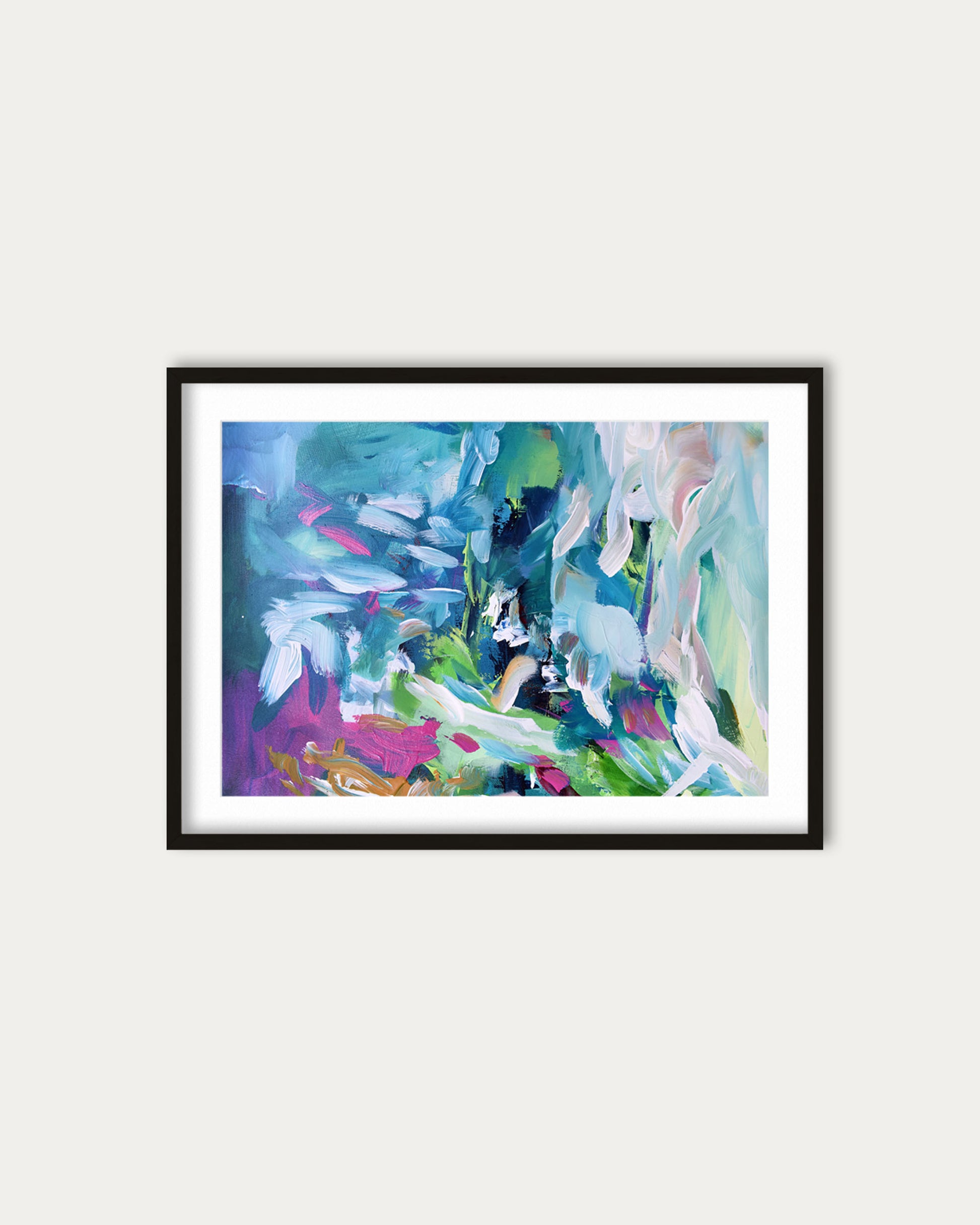 Framed abstract painting with colorful brushstrokes on a white wall