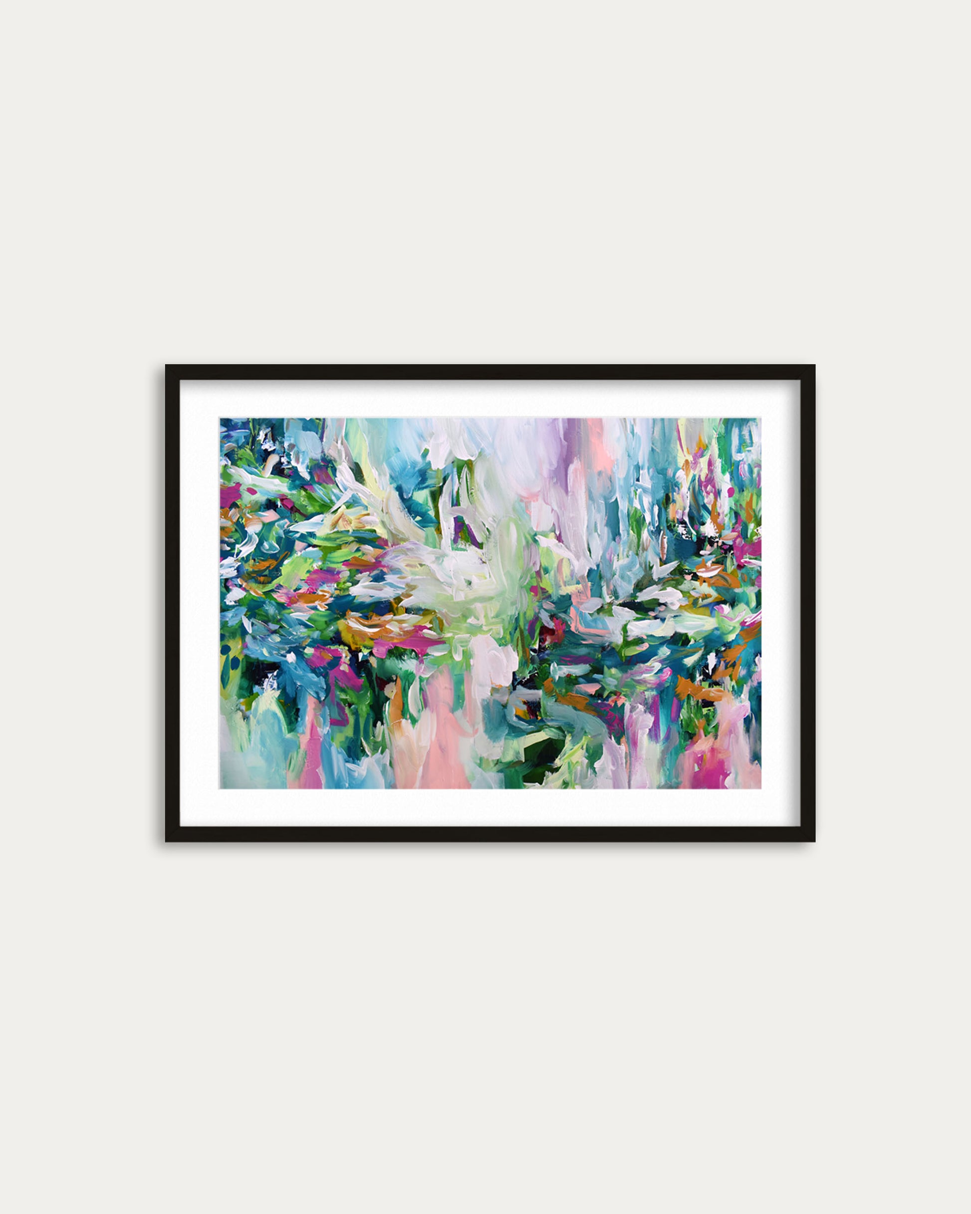 Framed abstract painting with vibrant colors on a white wall