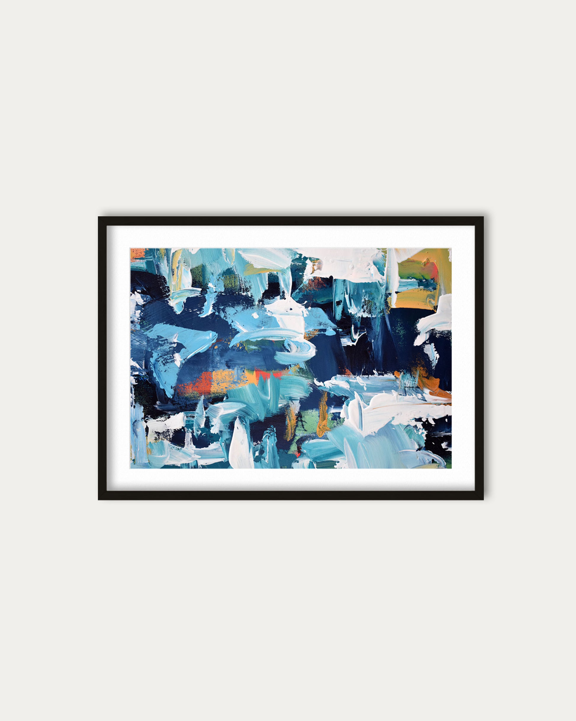 Framed abstract art print with blue and multicolor design on a white wall