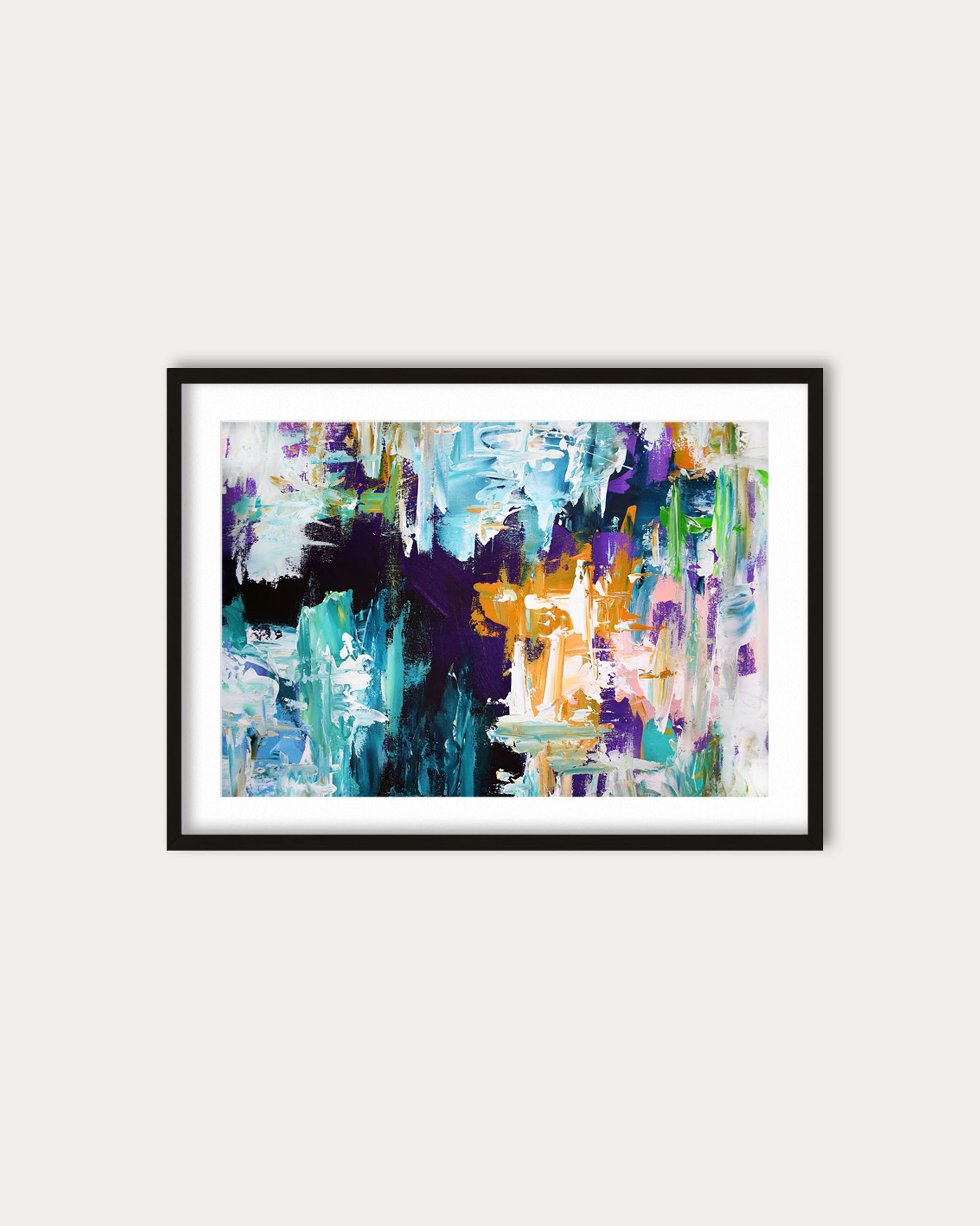 Framed abstract painting with colorful brush strokes on a white wall