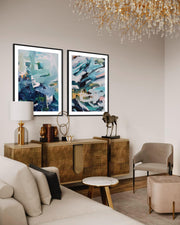 Modern living room with abstract art, wooden console table, and chandelier.