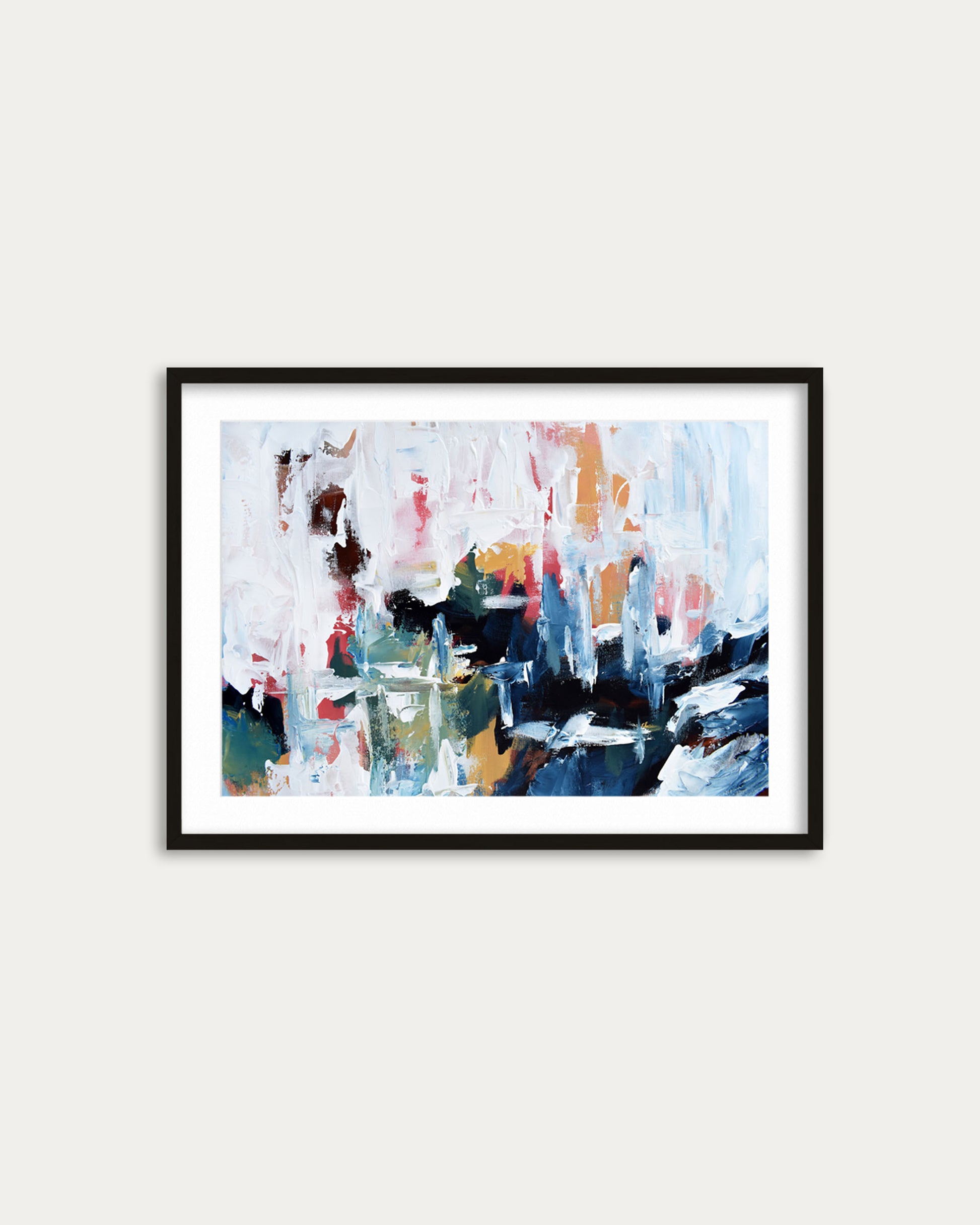Framed abstract painting with multicolors on a white wall