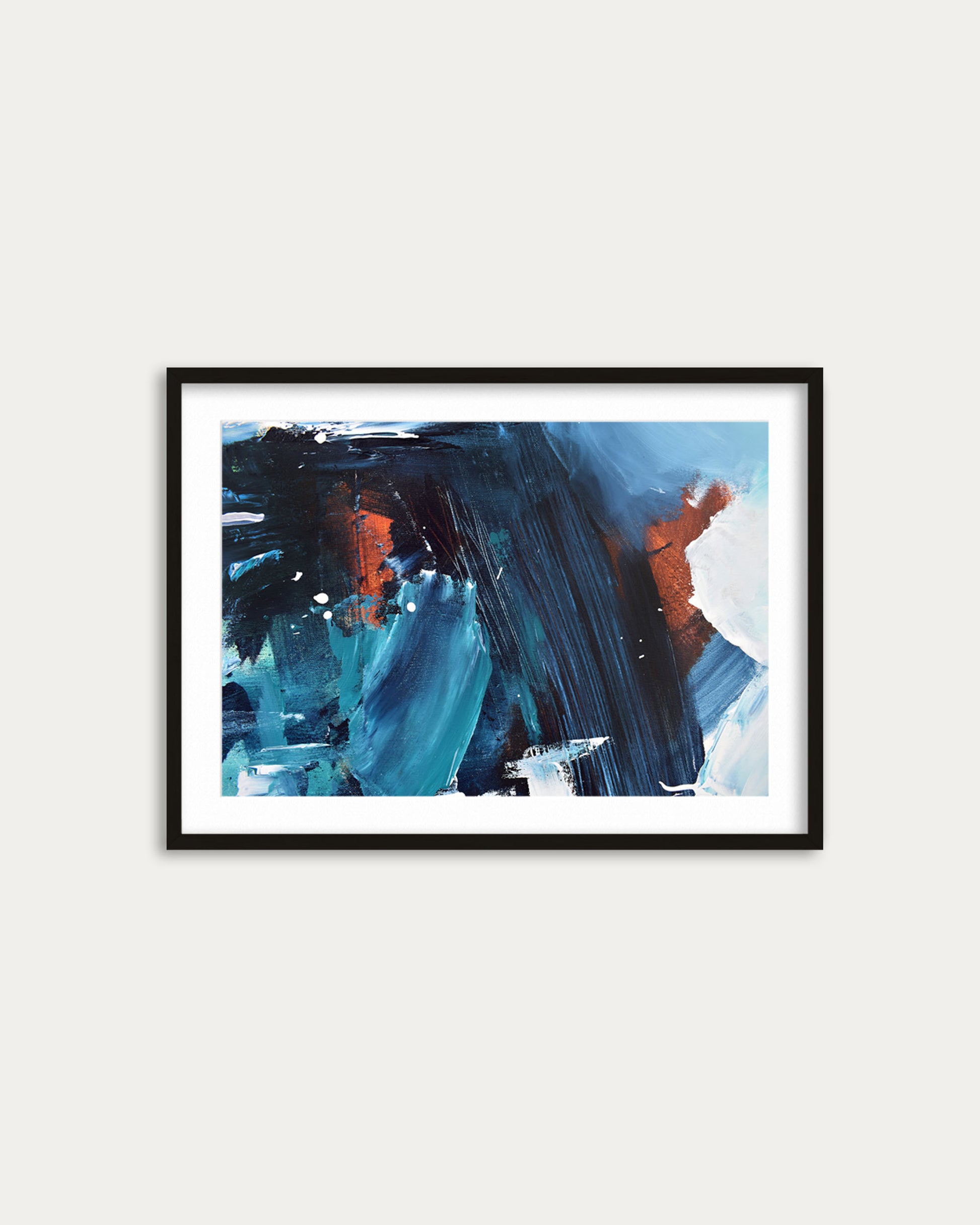 Framed abstract painting with blue and orange brushstrokes on a white wall