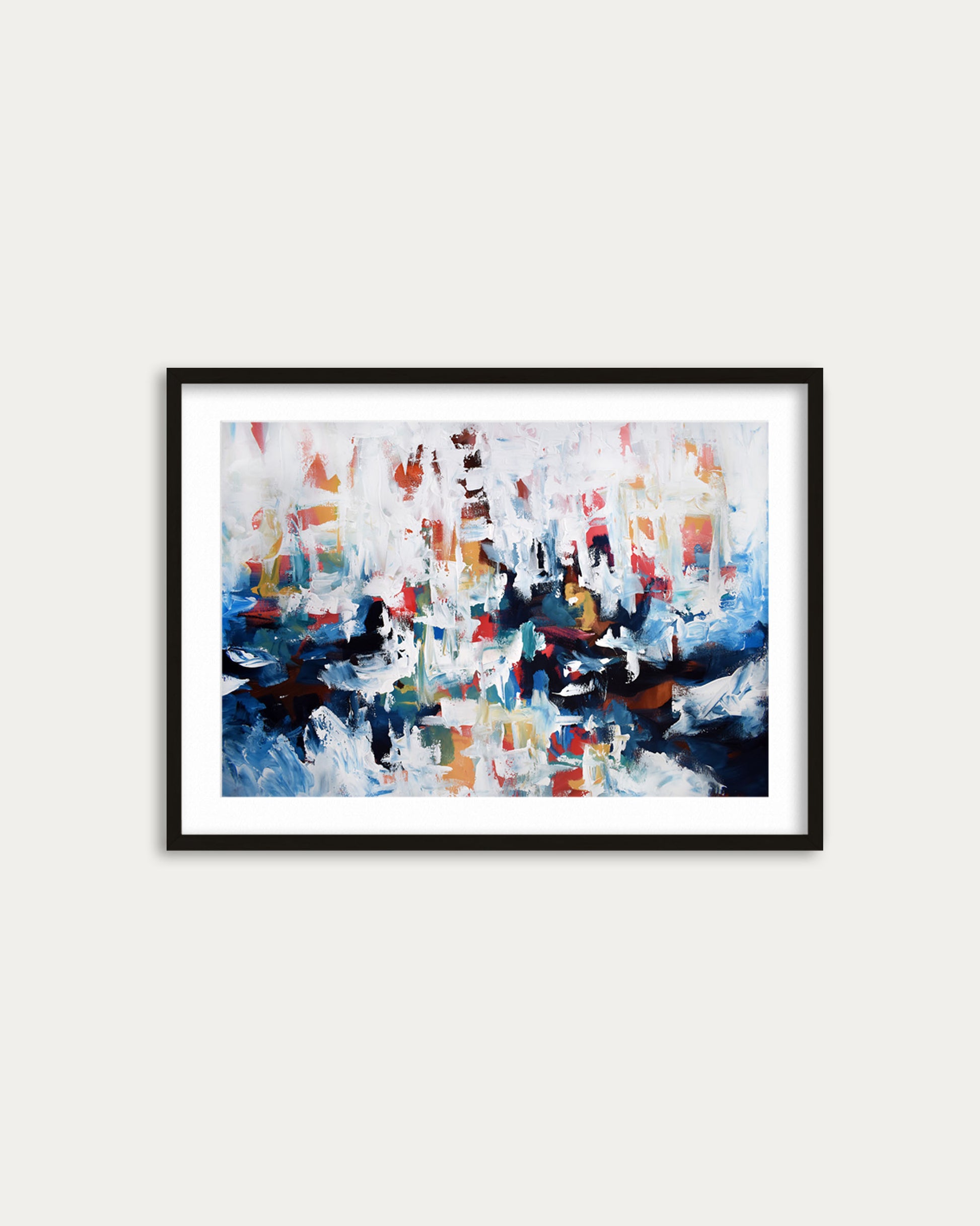 Framed abstract painting with colorful brush strokes on a white wall