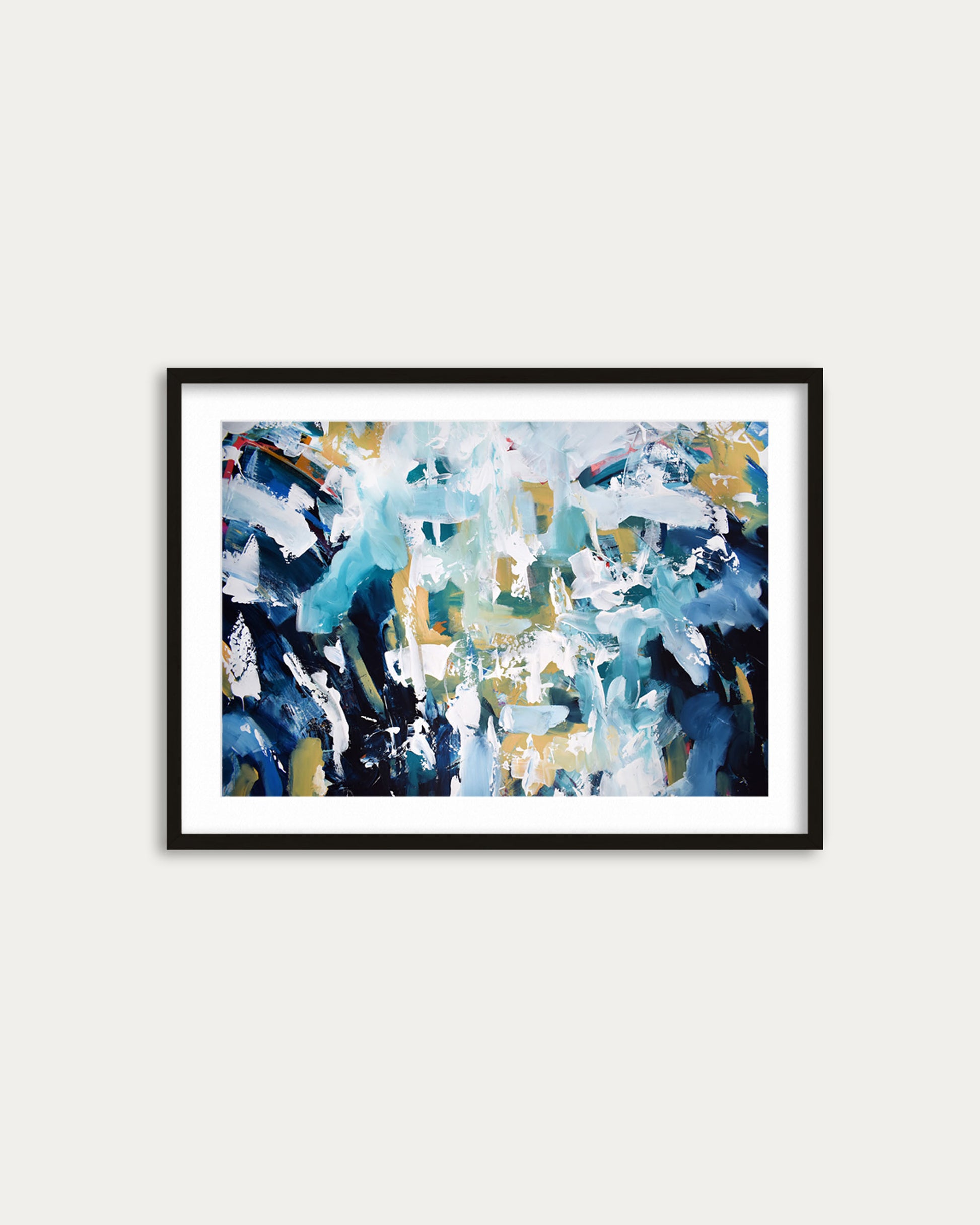 Framed abstract art print with blue, white, and black colors on a white wall.