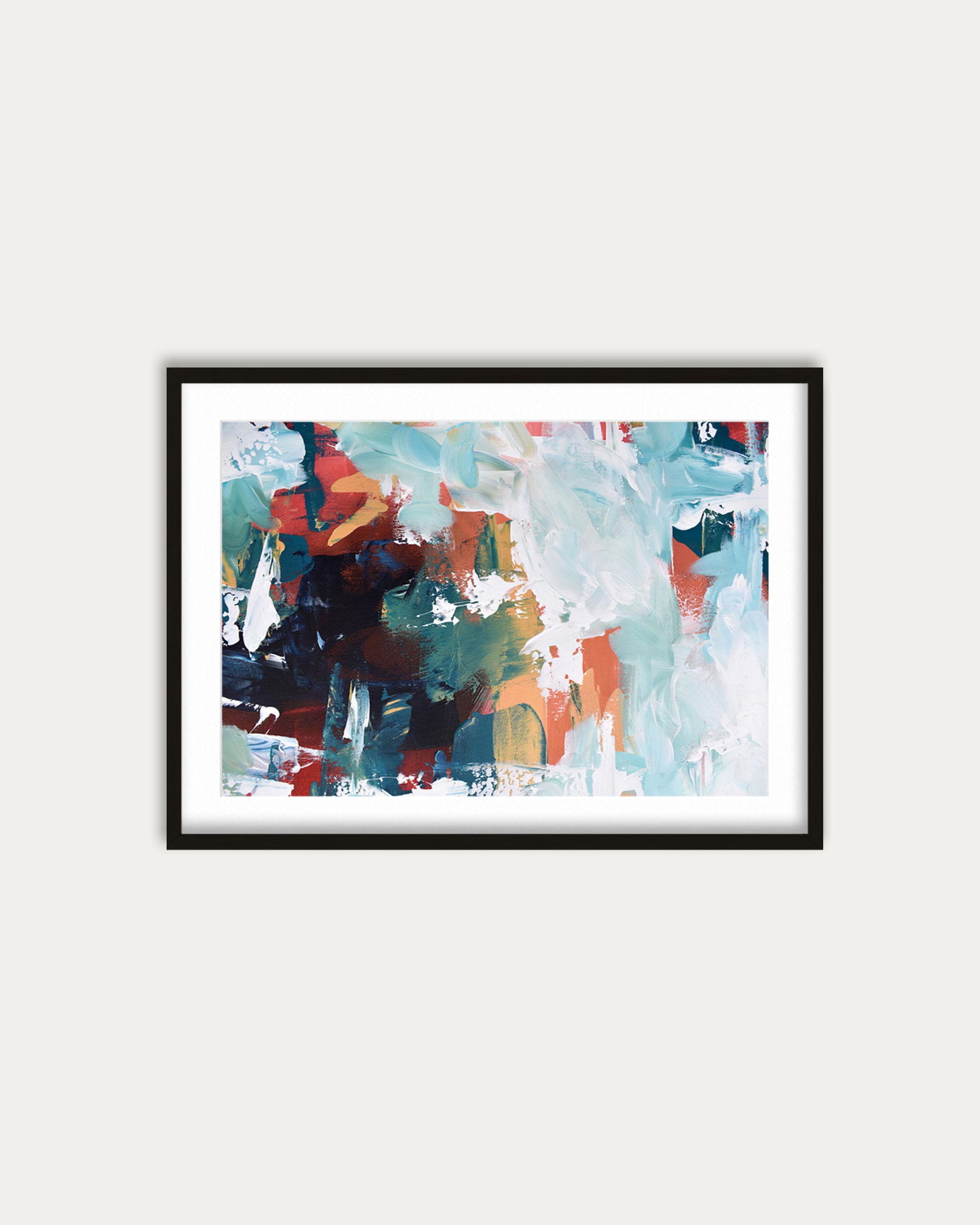 Framed abstract painting with colorful brush strokes on a white wall
