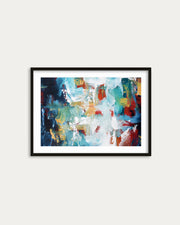 Framed abstract art print with colorful brush strokes on a white wall