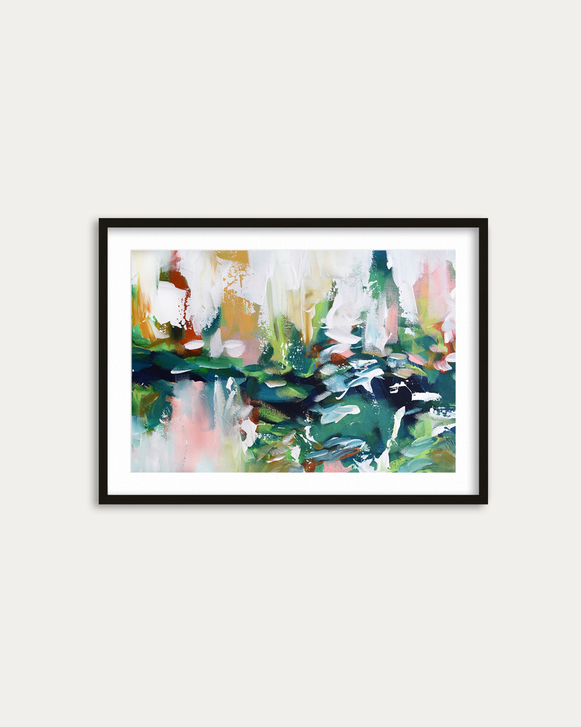 Framed abstract painting with colorful brush strokes on a white wall
