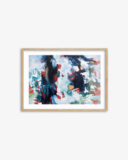 Framed abstract art print with colorful brush strokes on a white wall