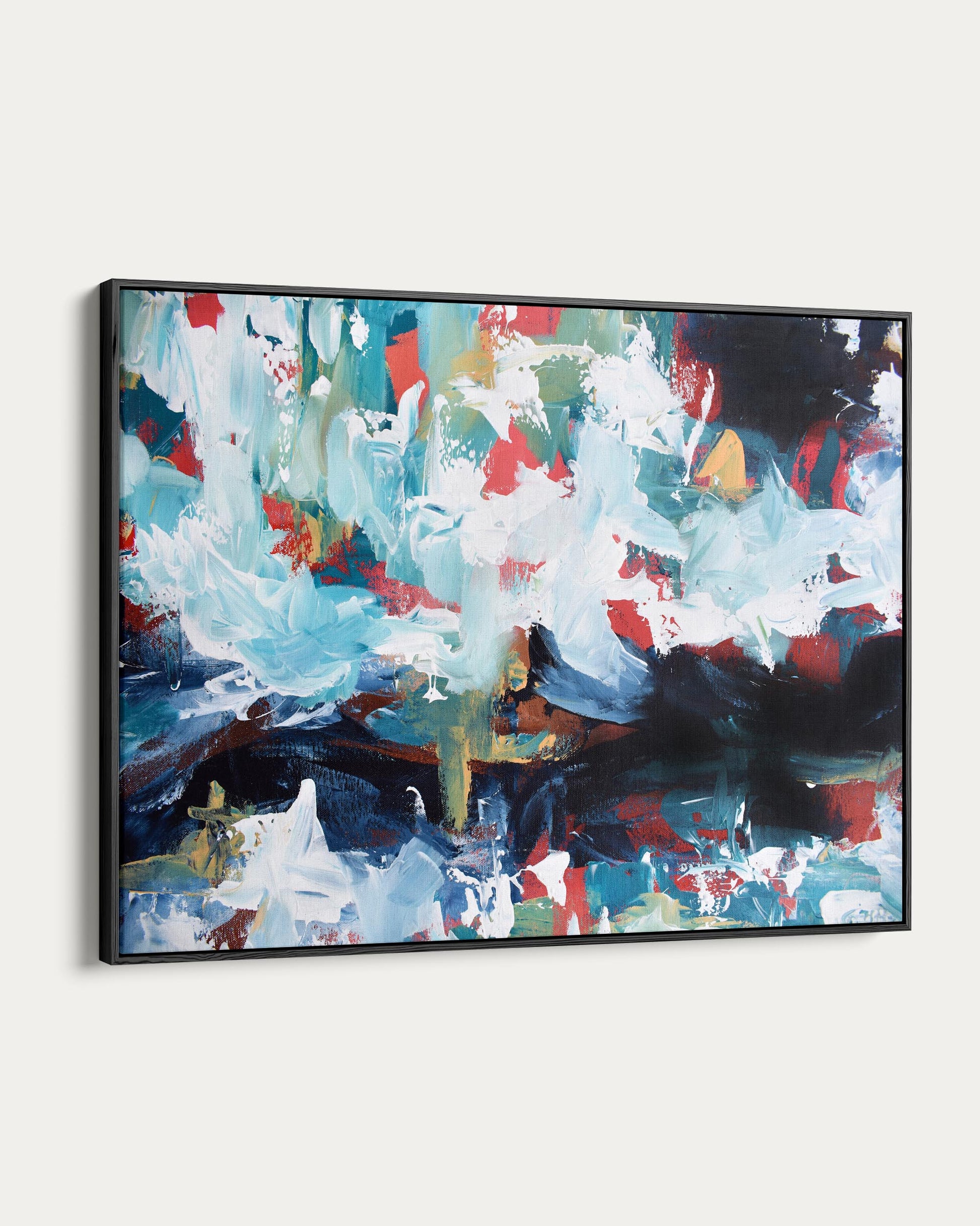 Abstract painting with splashes of blue, red, and white on a white wall.