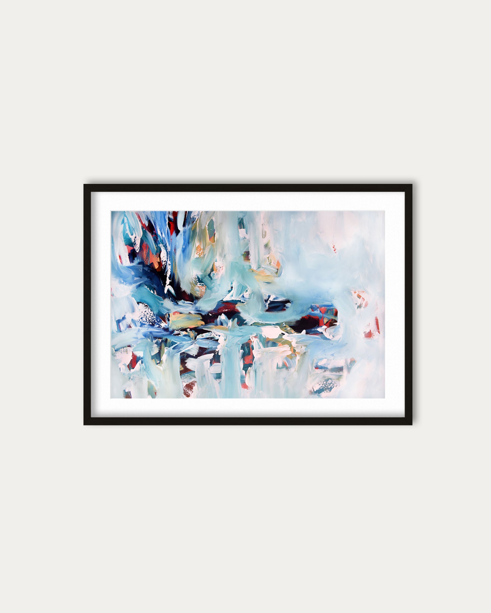 Framed abstract artwork with colorful brush strokes on a white wall