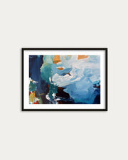 Framed abstract art print with blue and orange colors on a white wall