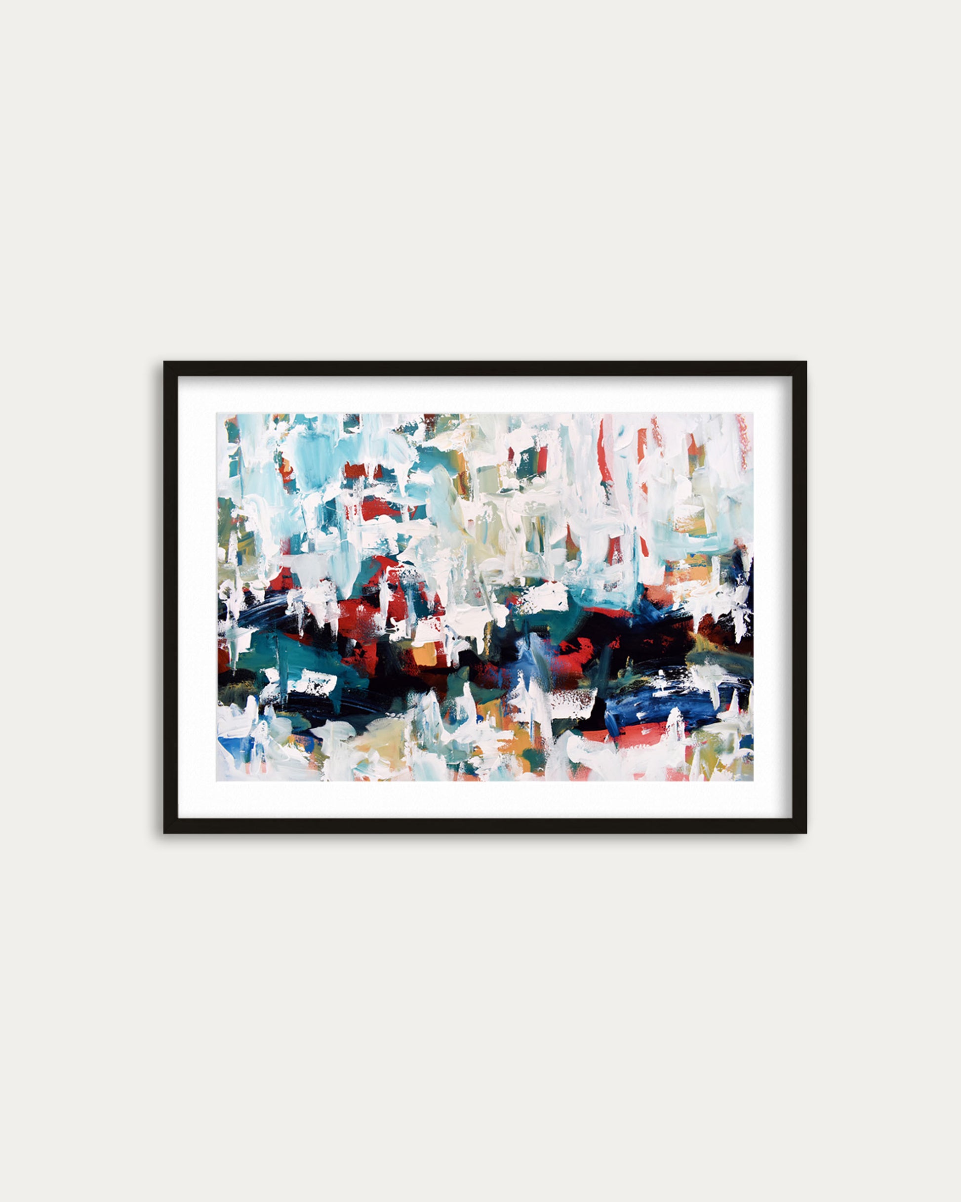 Framed abstract art print with colorful brush strokes on a white wall
