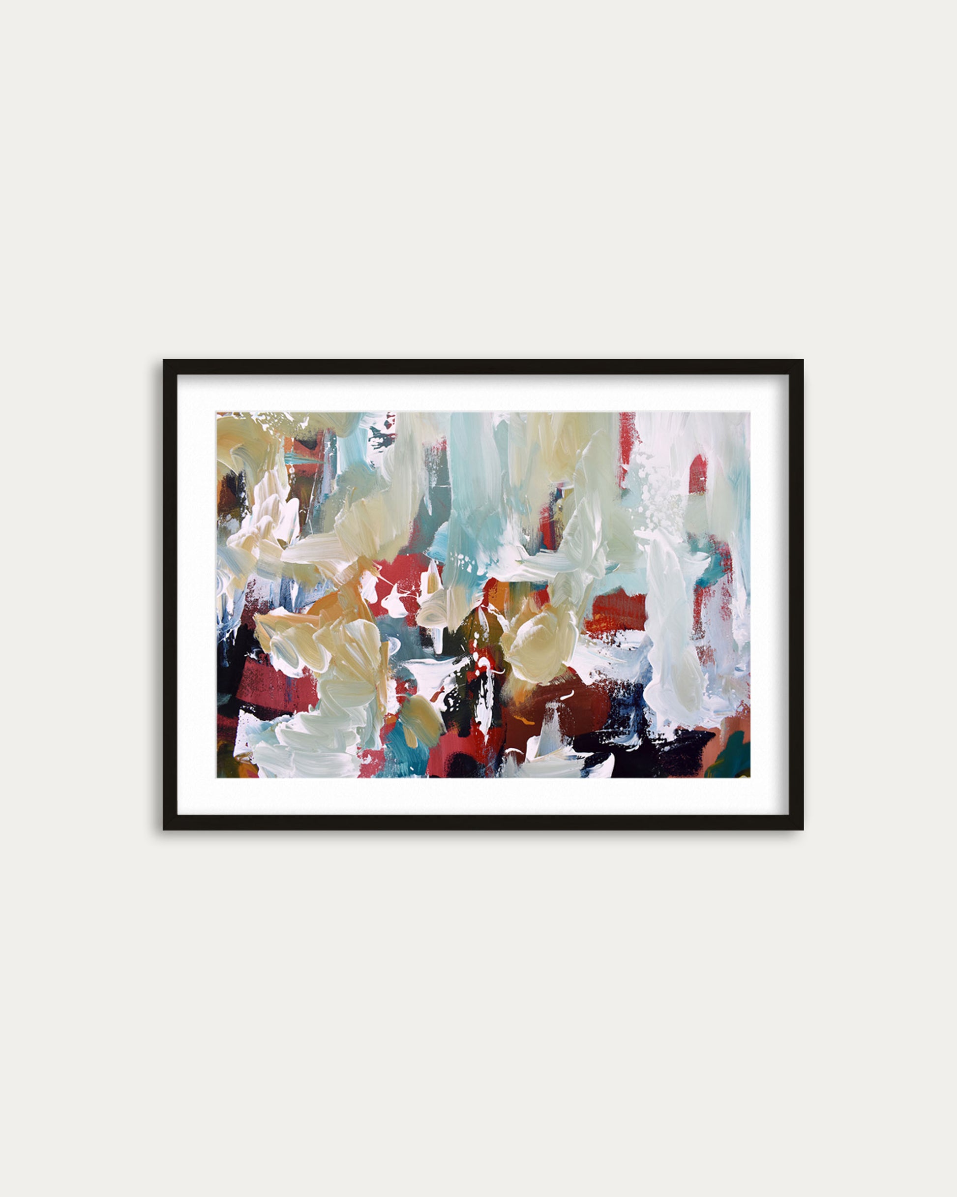 Framed abstract painting with colorful brush strokes on a white wall