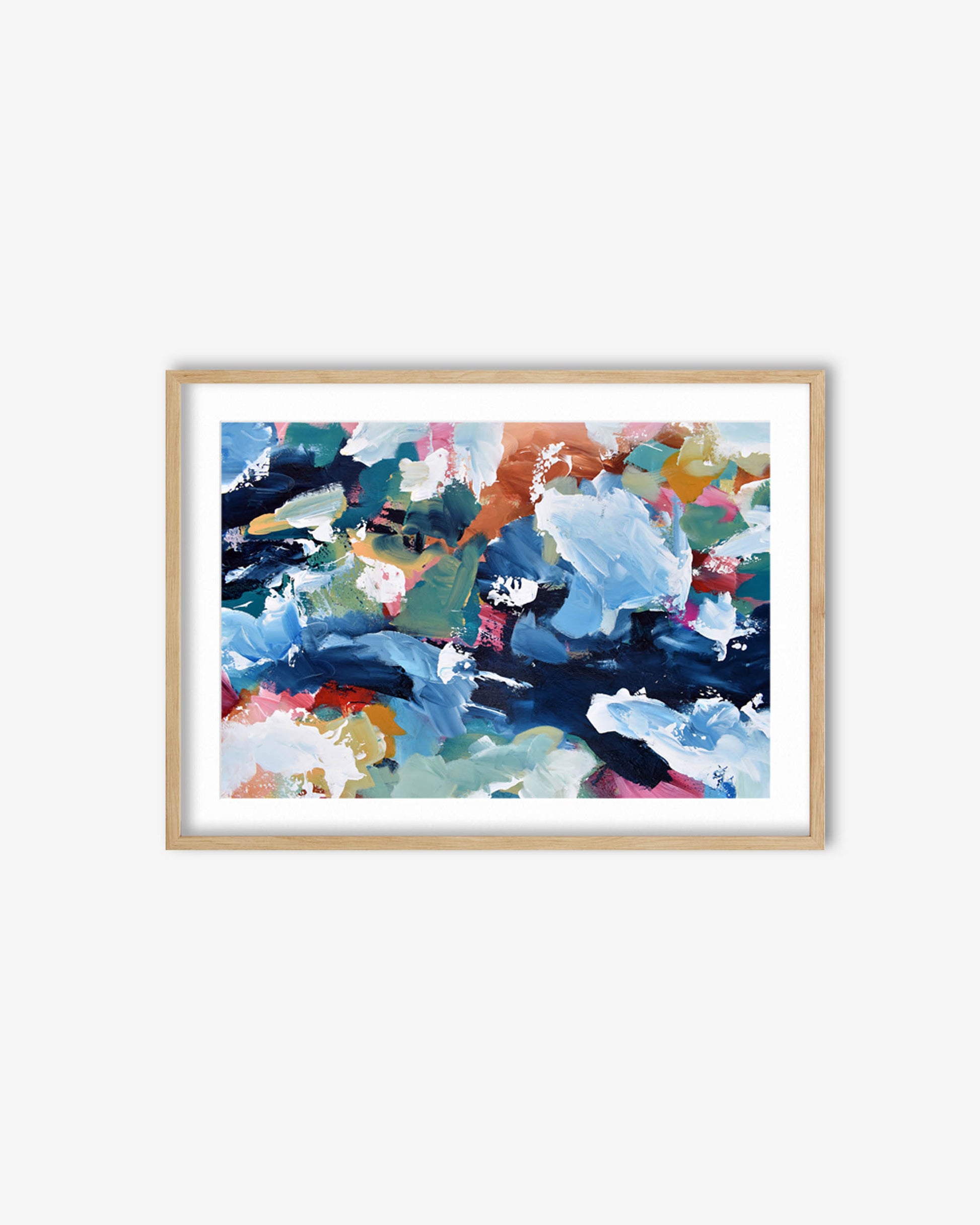 Framed abstract art print with colorful brush strokes on a white wall