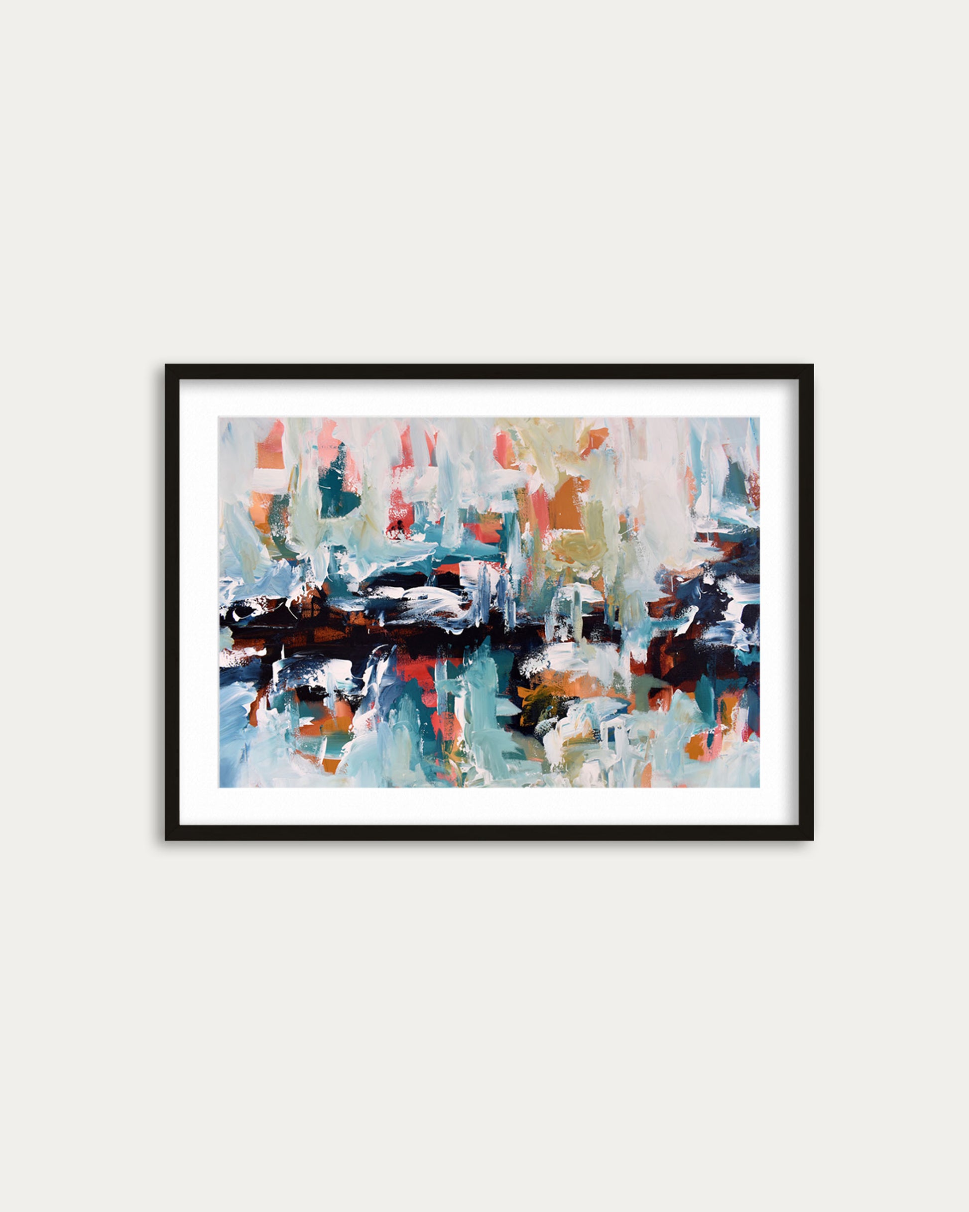 Framed abstract painting with multicolors on a white wall