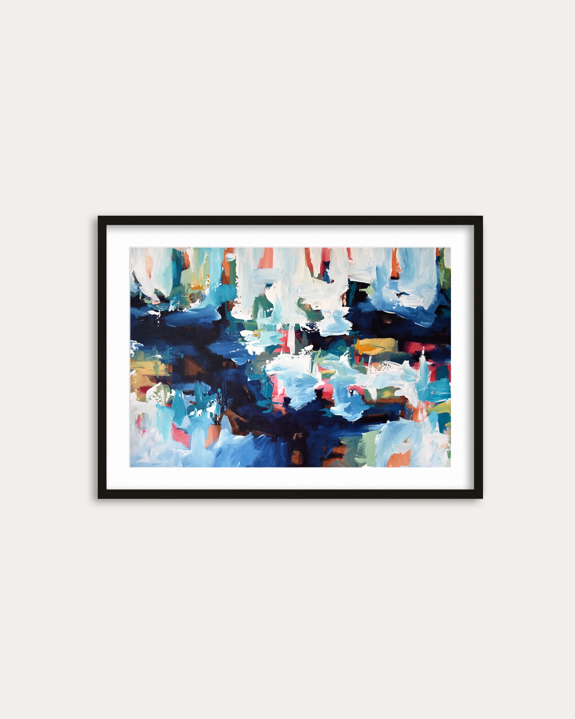 Framed abstract painting with colorful brush strokes on a white wall