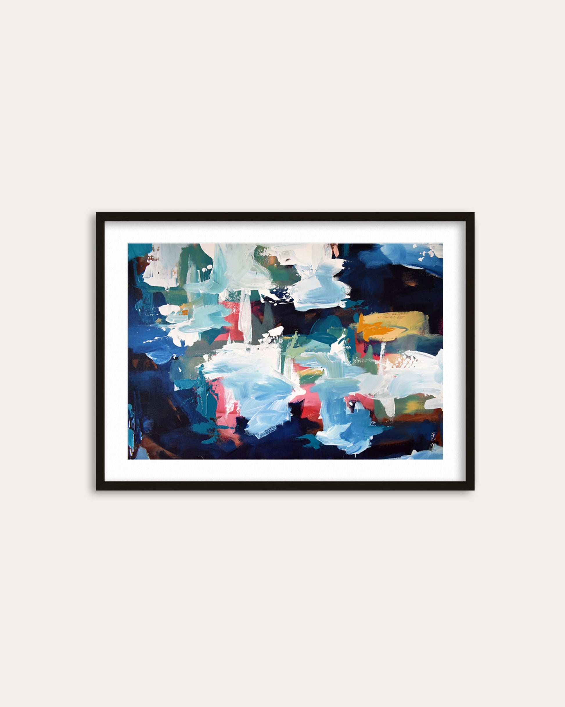 Framed abstract art print with colorful brush strokes on a white wall