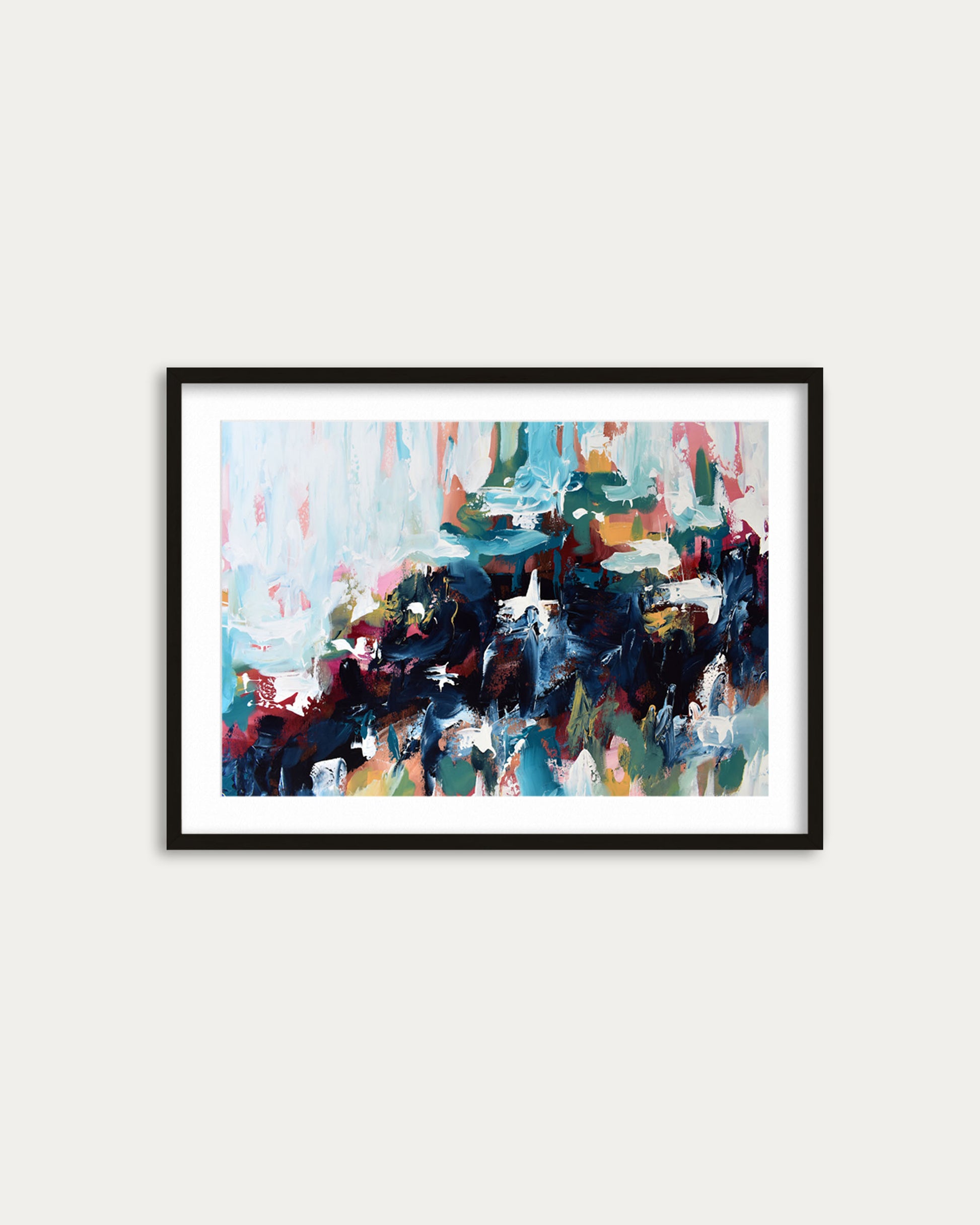 Framed abstract painting with colorful brush strokes on a white wall