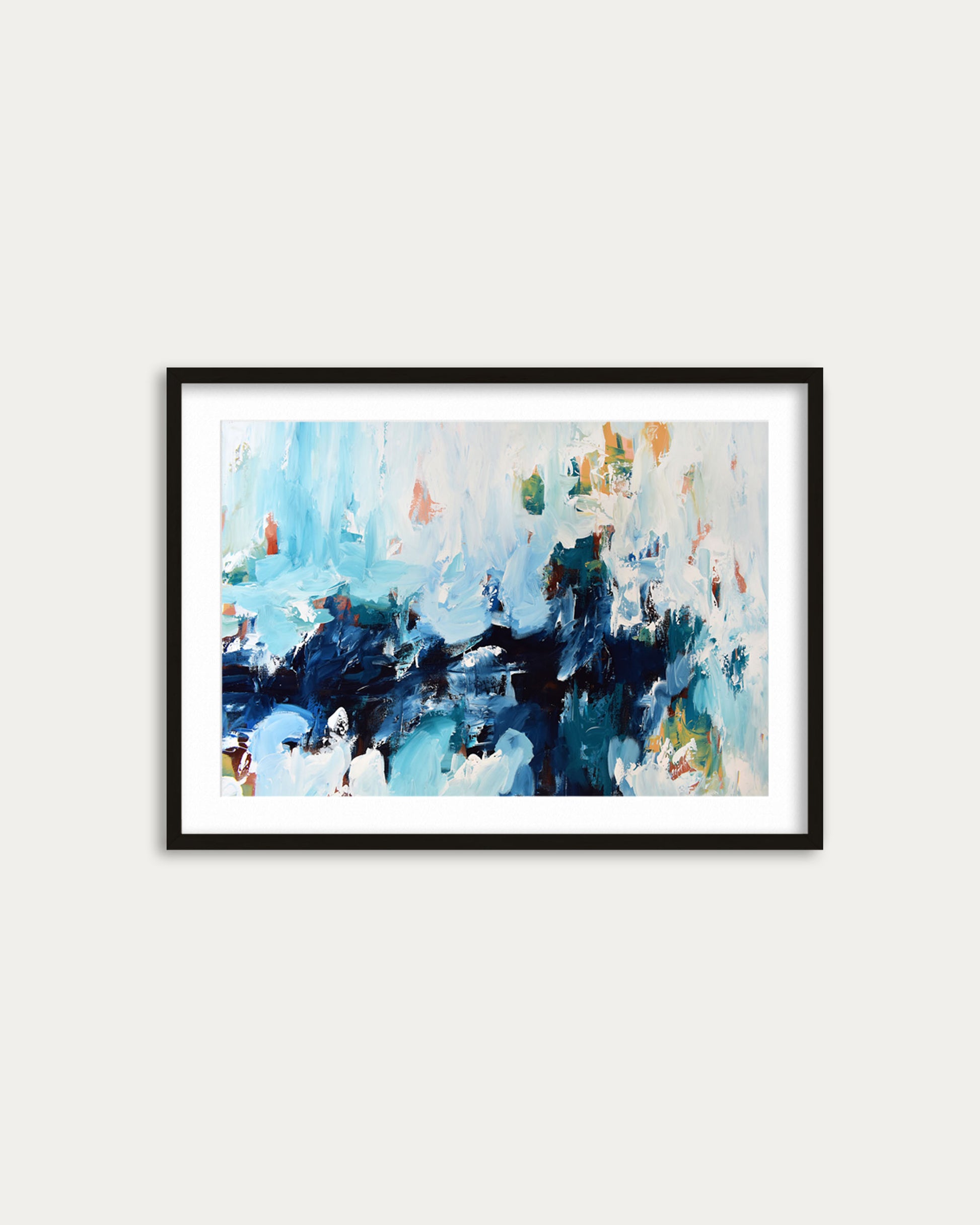 Framed abstract painting with blue and green tones on a white wall