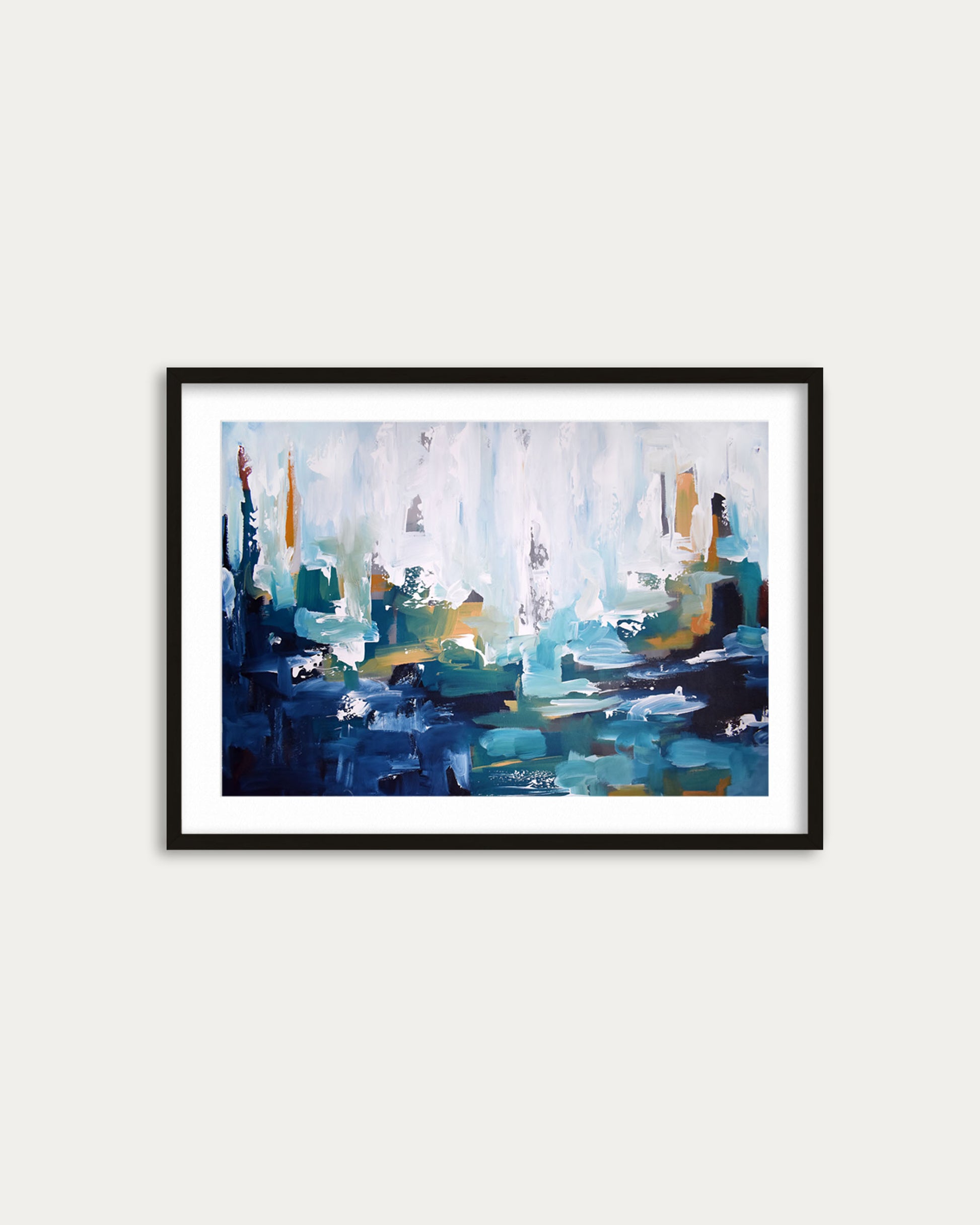 Framed abstract painting with blue and green tones on a white wall