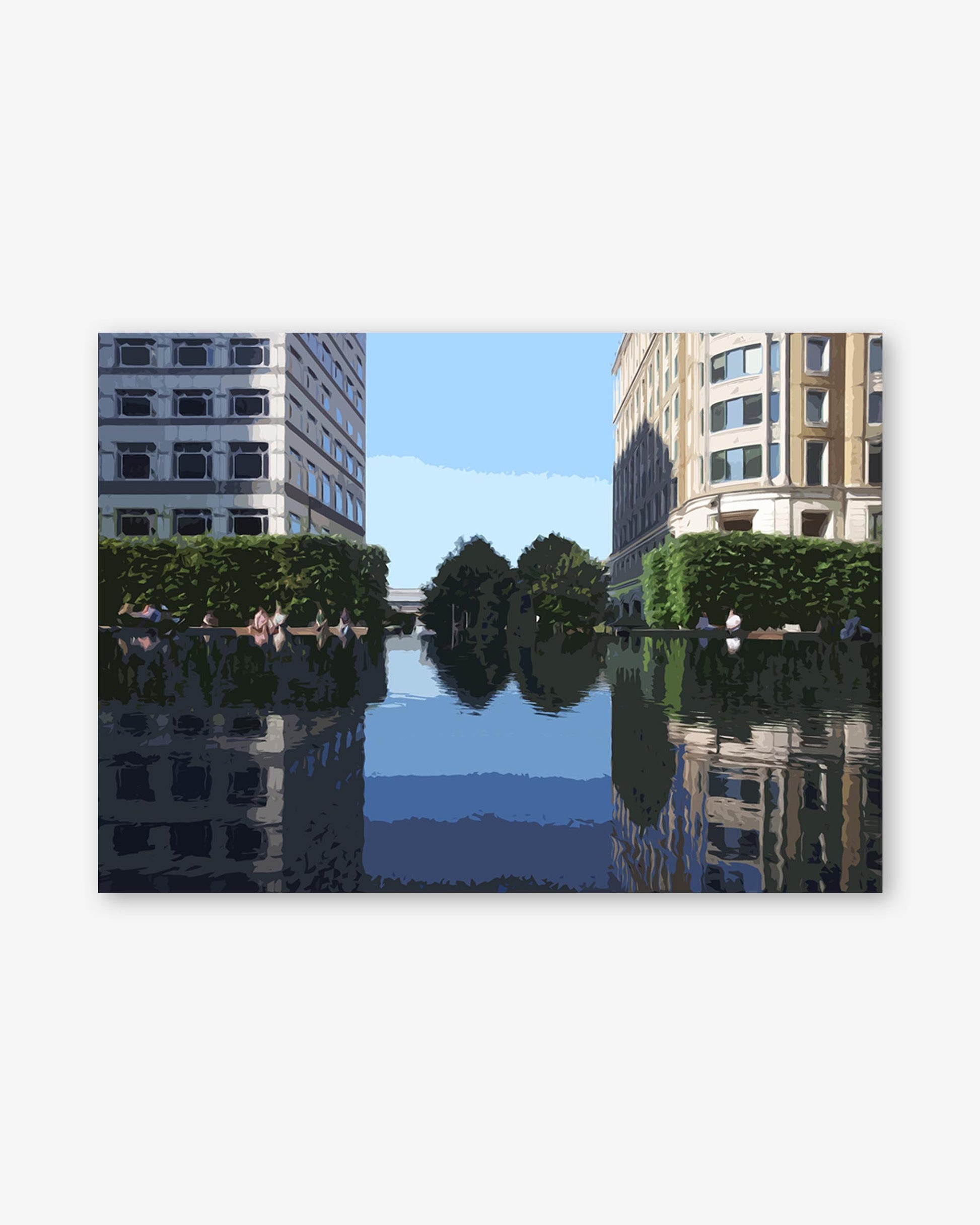 Reflection of buildings in a body of water with trees in the background