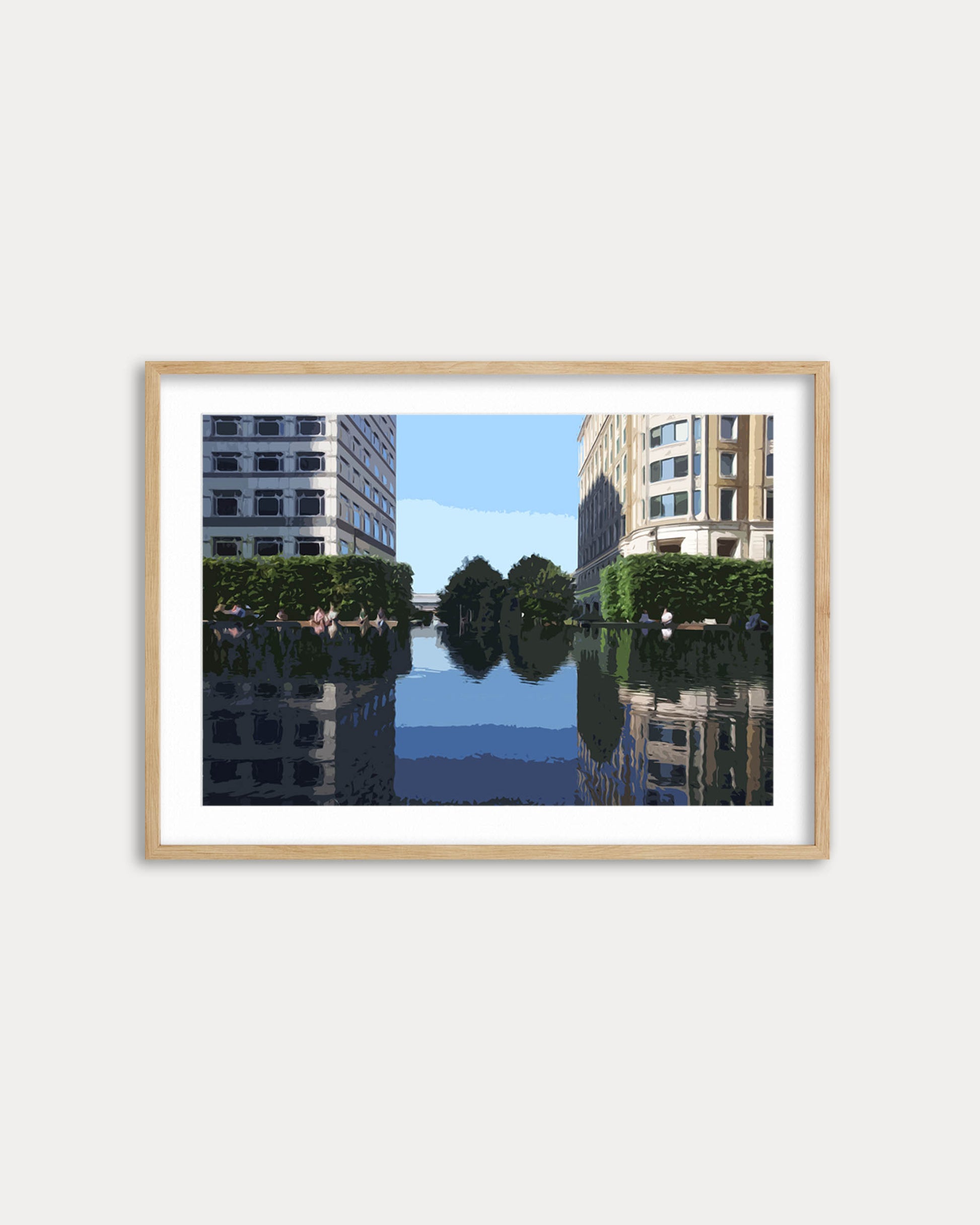 Framed artwork of a cityscape with buildings and water on a white wall