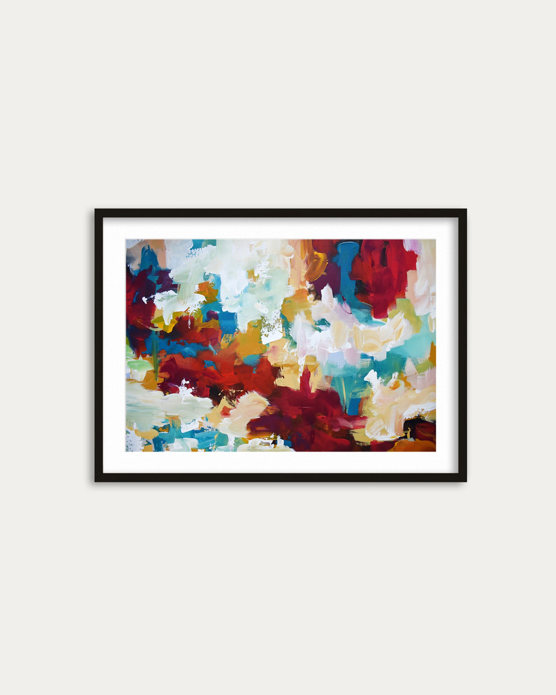 Framed abstract artwork with multicolors on a white wall