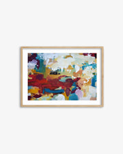 Framed abstract painting with colorful brush strokes on a white wall