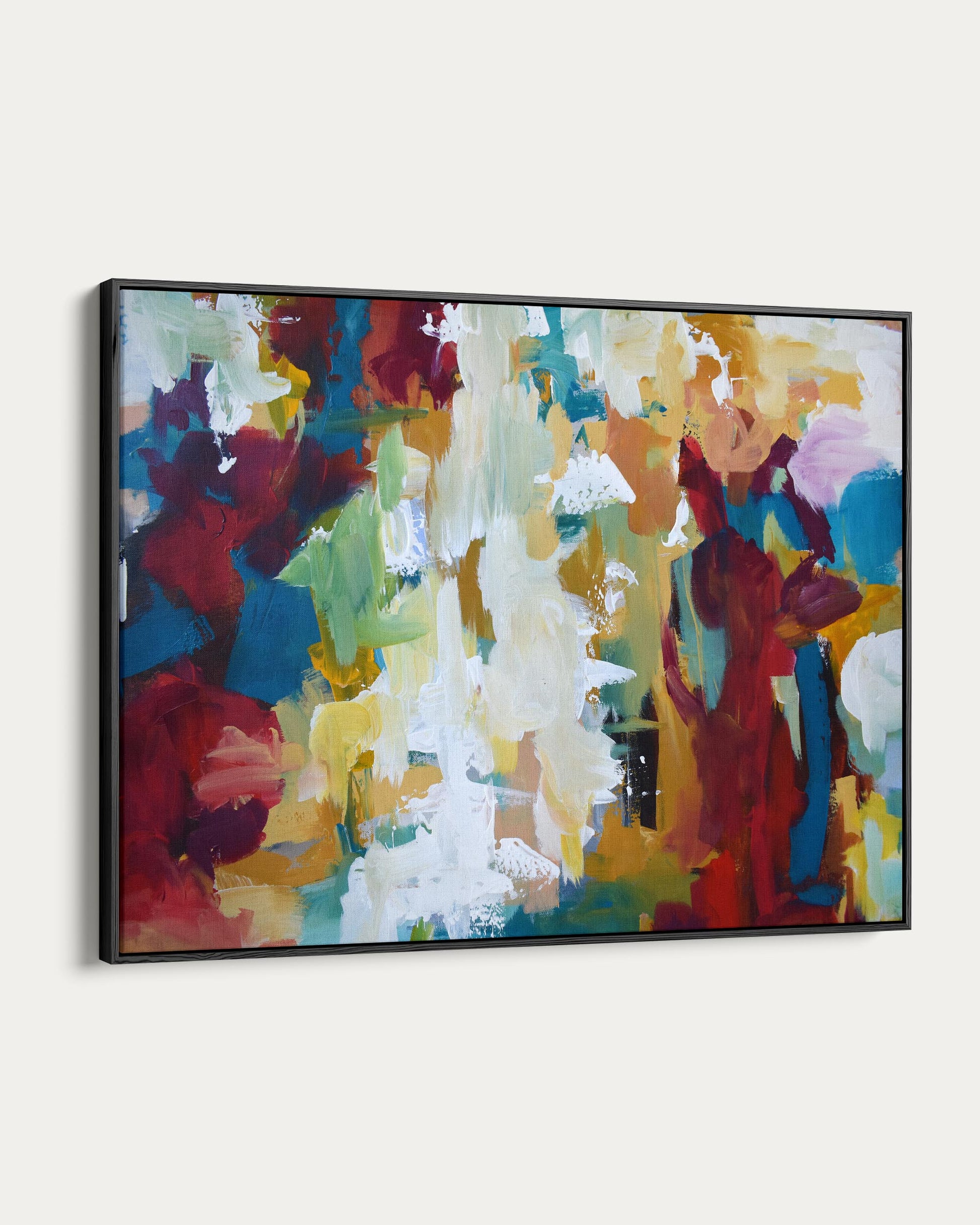 Abstract painting with vibrant colors on a white wall