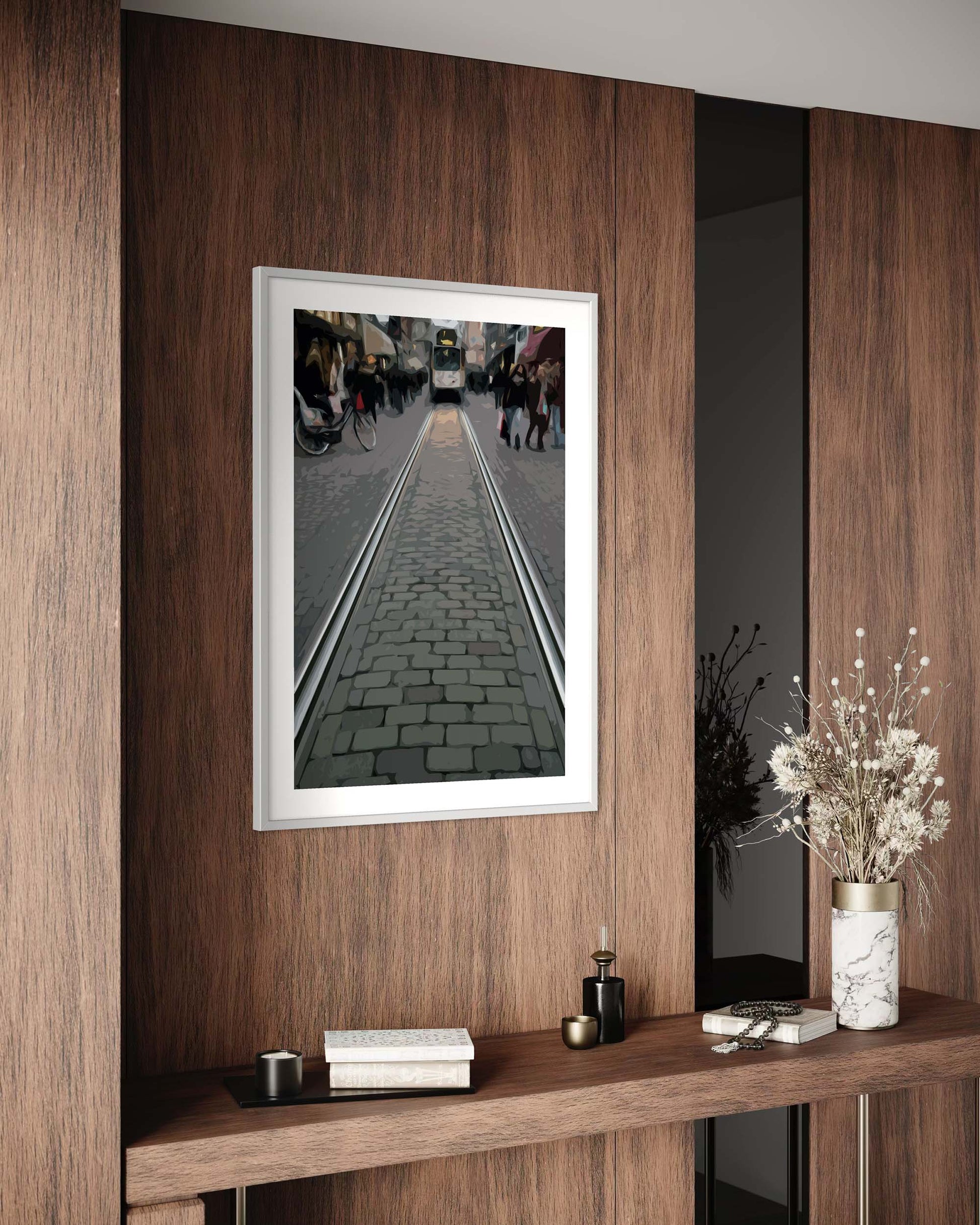 Framed photograph of a street scene on a wooden wall above a console table.