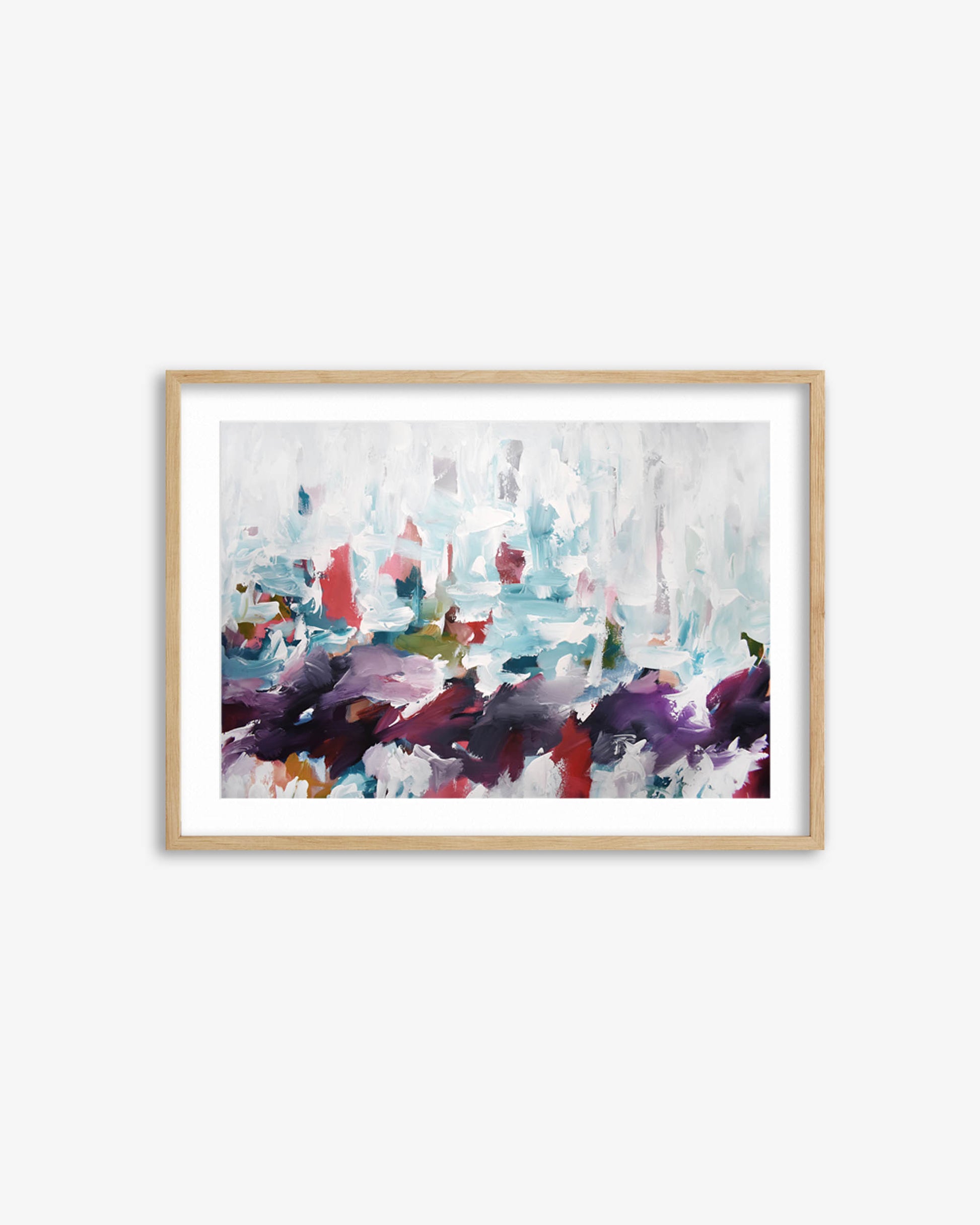 Framed abstract art print with colorful brush strokes on a white wall
