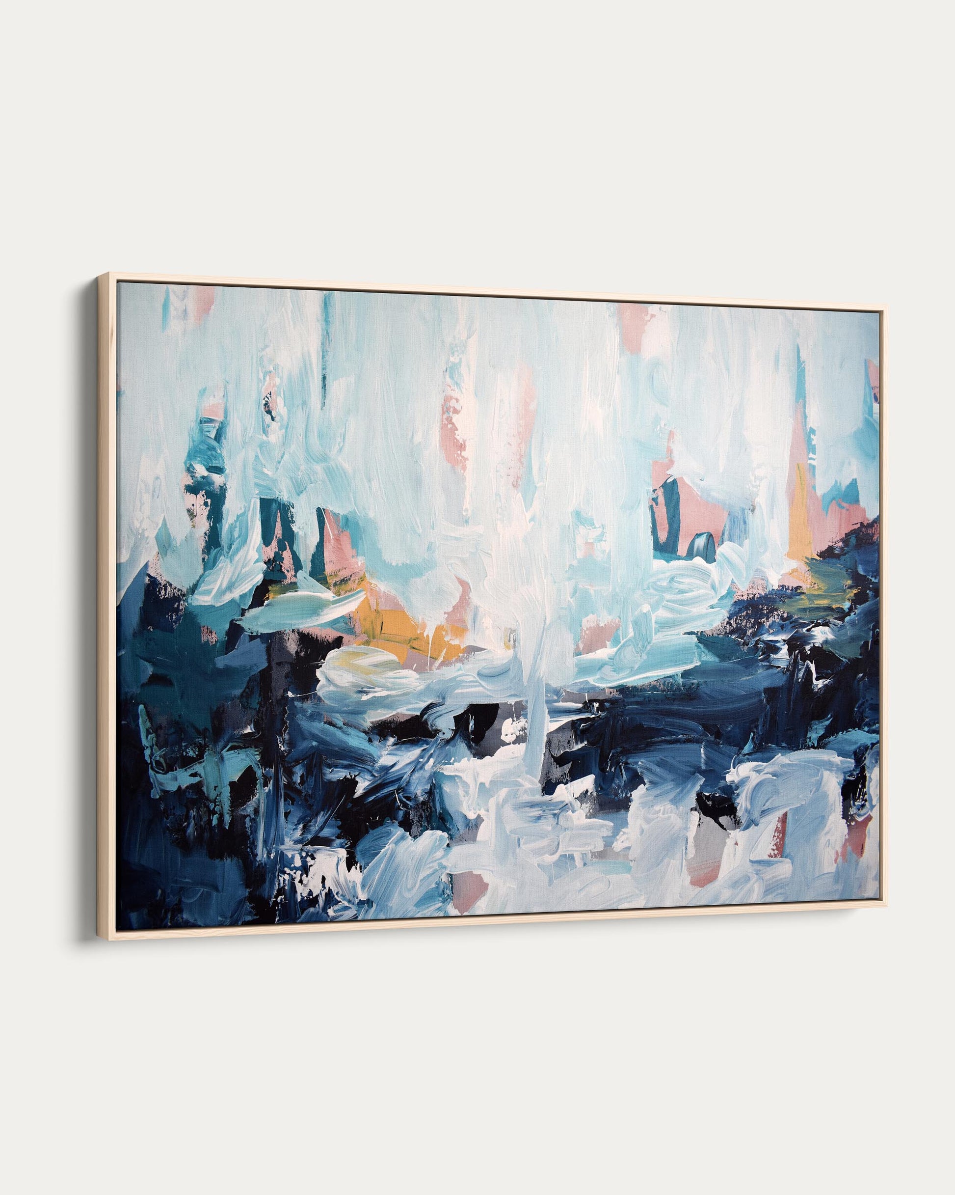 Abstract painting with blue, pink, and black colors on a white wall