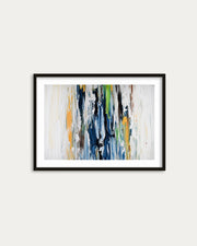 Framed abstract art print with colorful brush strokes on a white wall
