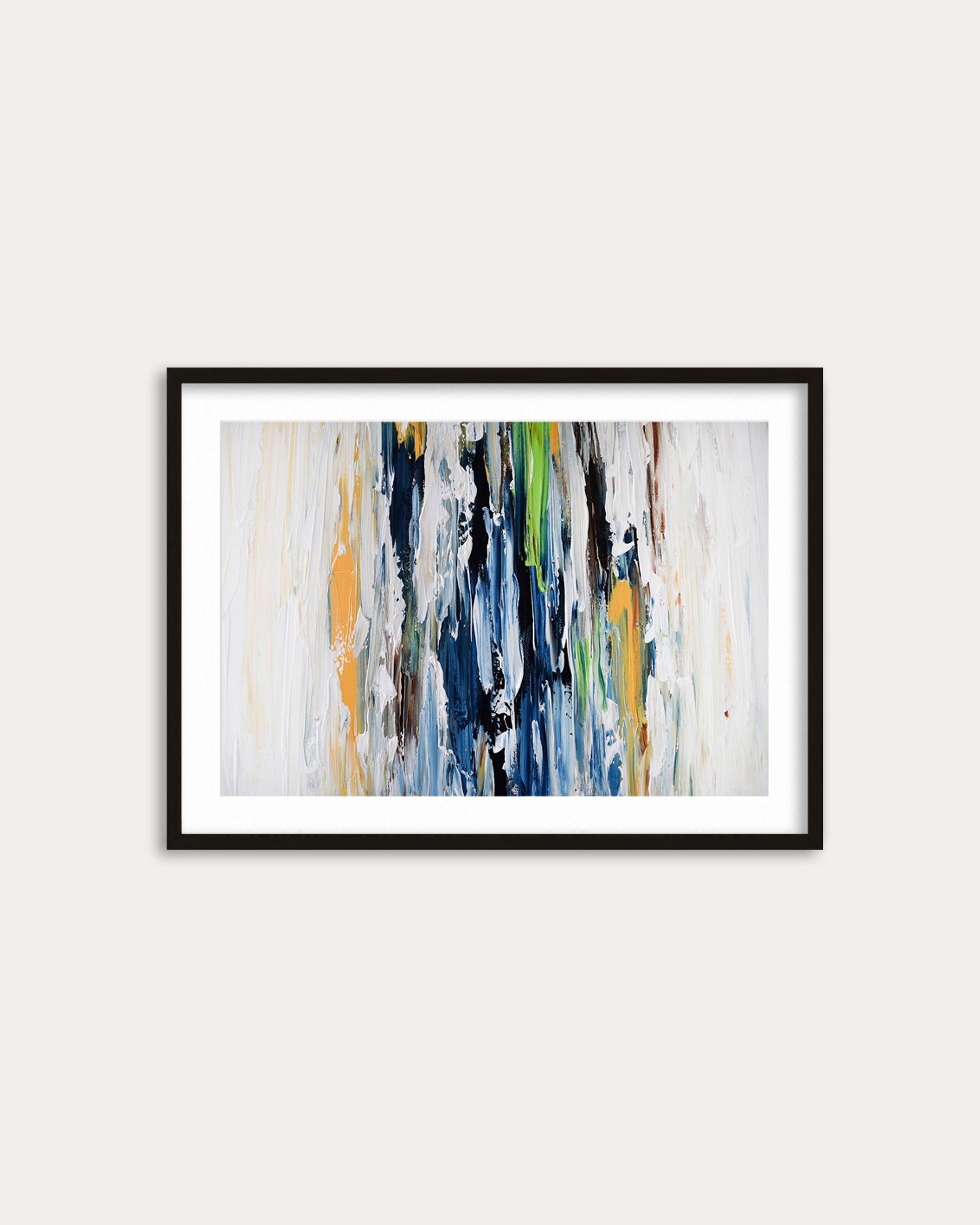 Framed abstract art print with colorful brush strokes on a white wall