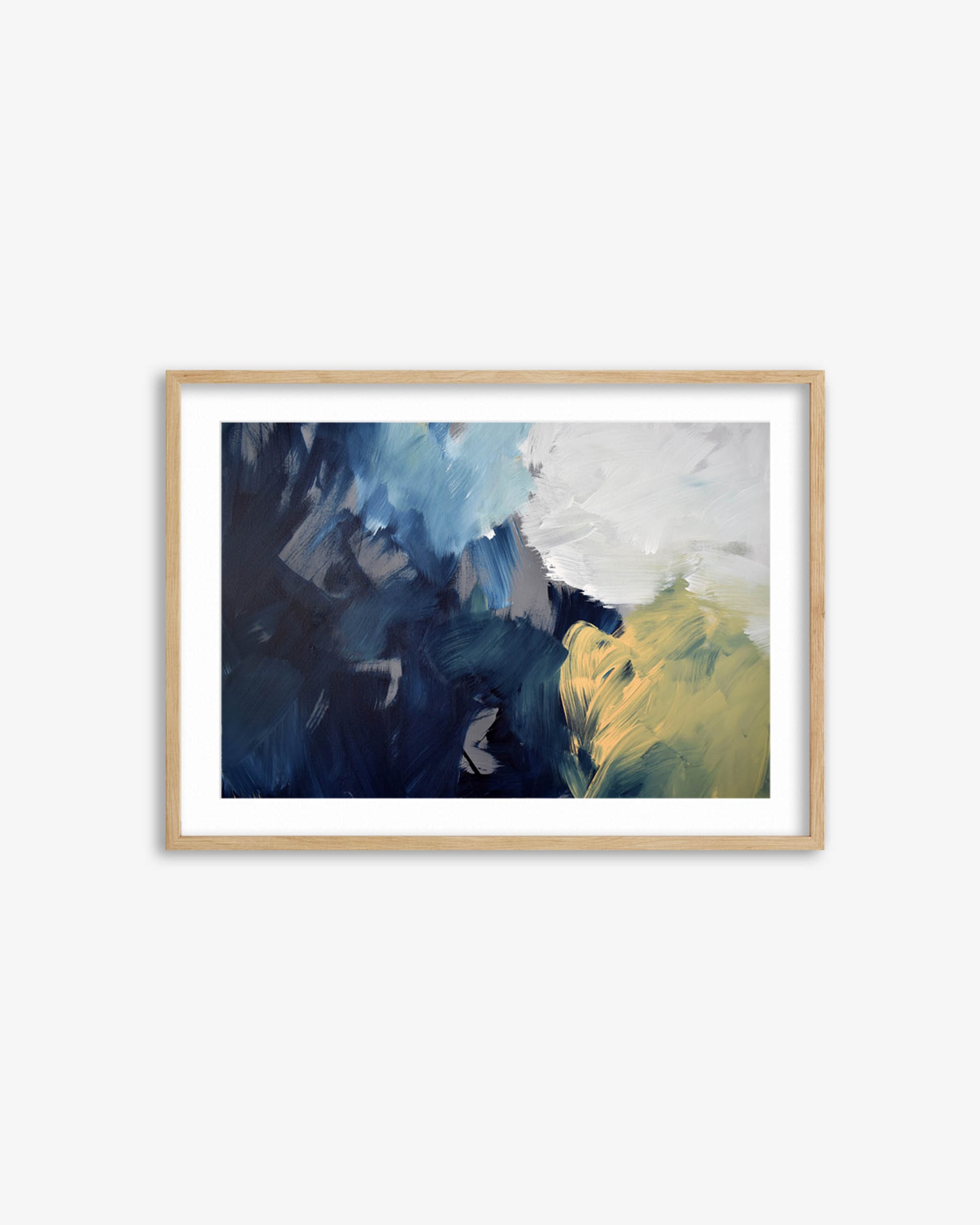 Framed abstract art print with blue and yellow colors on a white wall