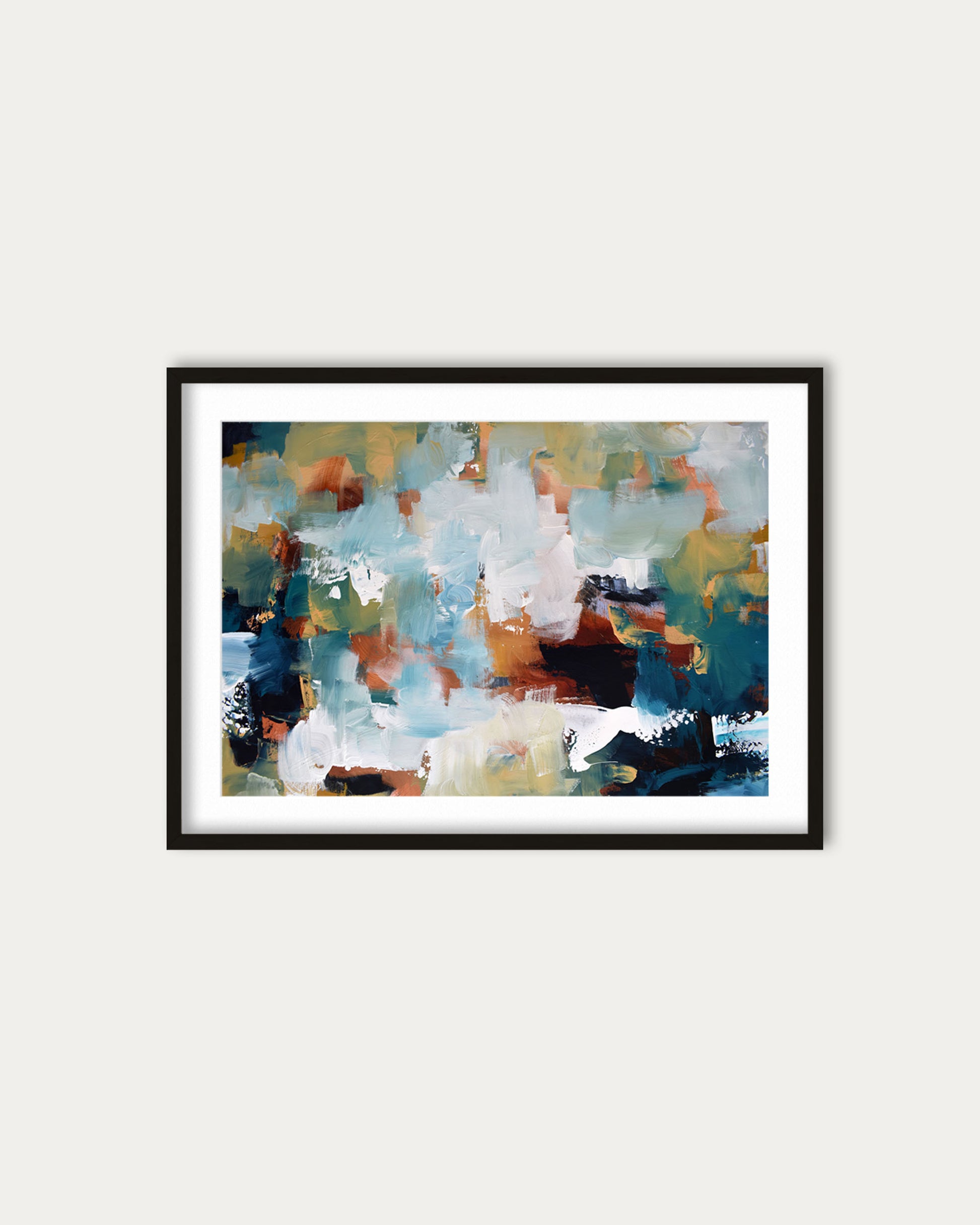 Framed abstract painting with multicolors on a white wall