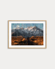 Framed artwork of a mountain landscape with autumn colors on a white wall.